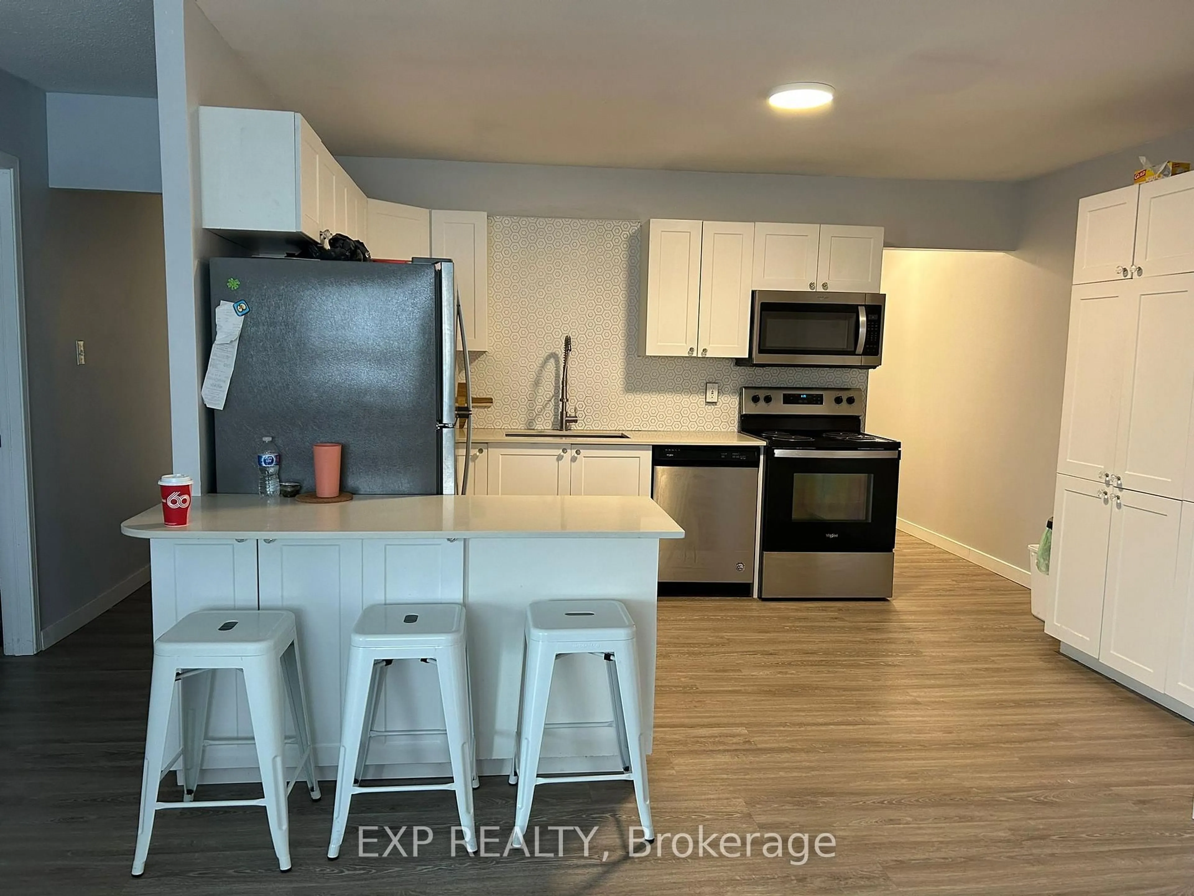 Open concept kitchen, wood/laminate floor for 91 Westmount Rd #3, Waterloo Ontario N2L 2R7