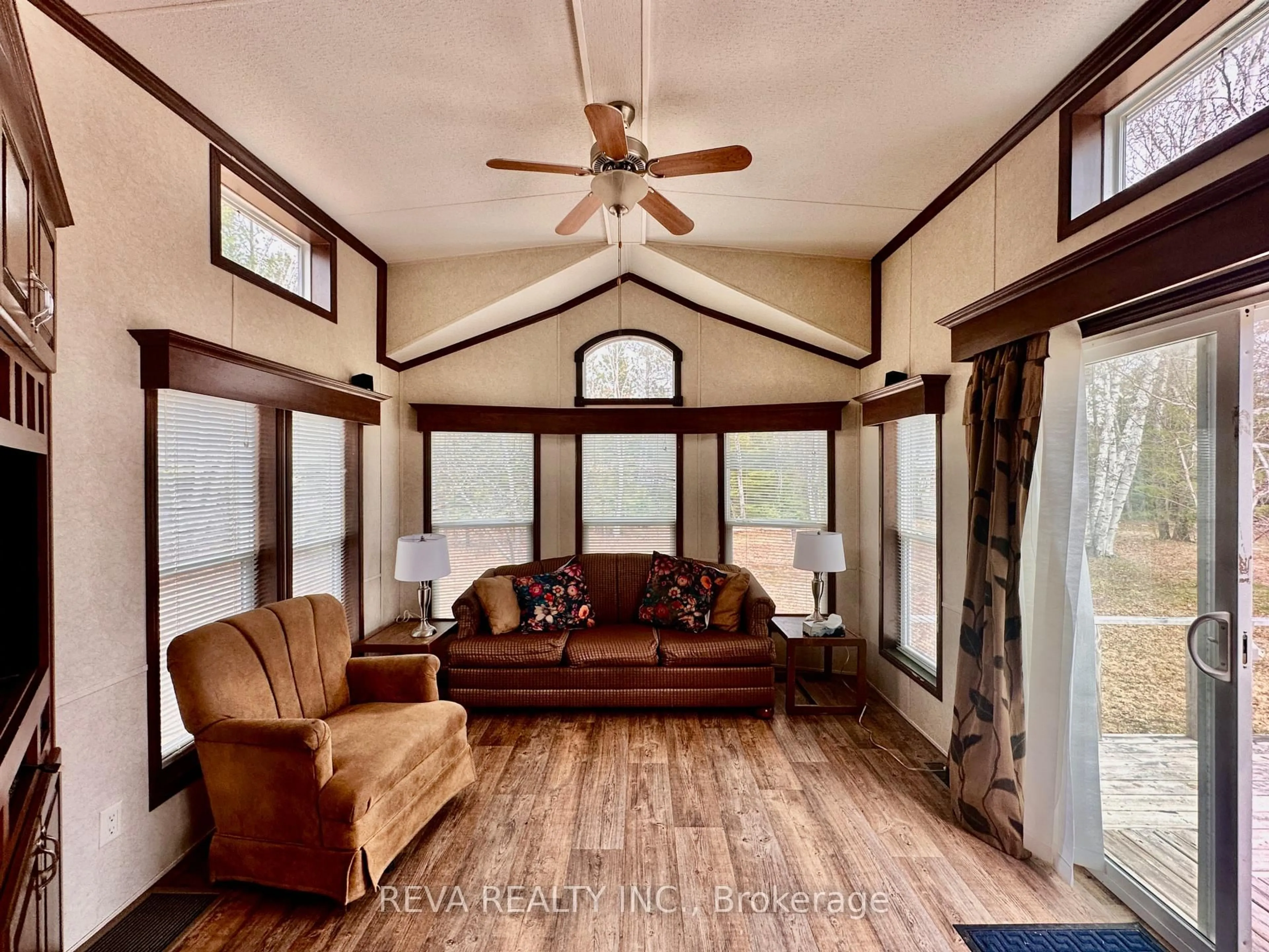 Living room with furniture, wood/laminate floor for 38 Boulter Lake Rd, Maynooth Ontario K0L 2K0