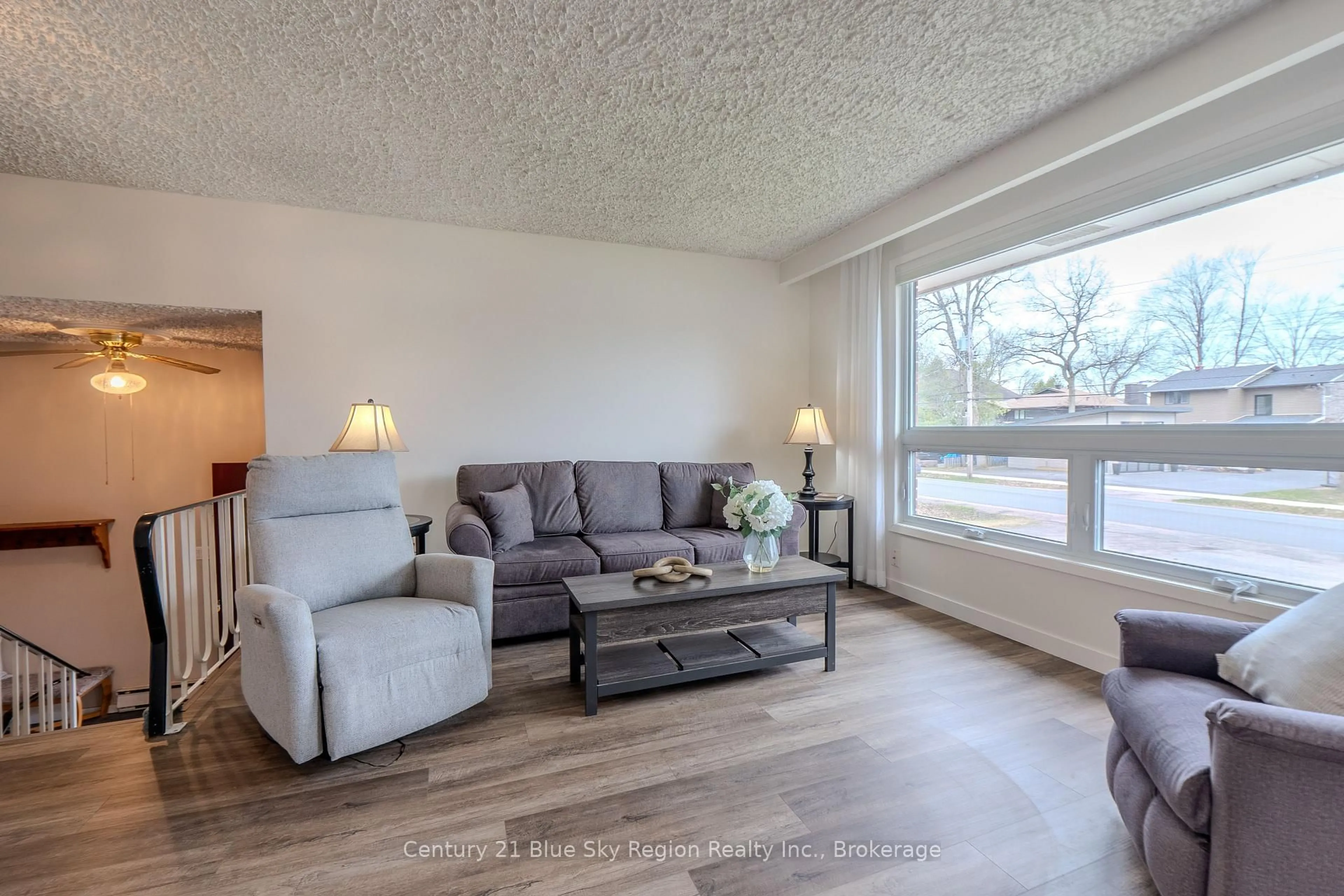 Living room with furniture, wood/laminate floor for 1064 Premier Rd, North Bay Ontario P1A 2J1