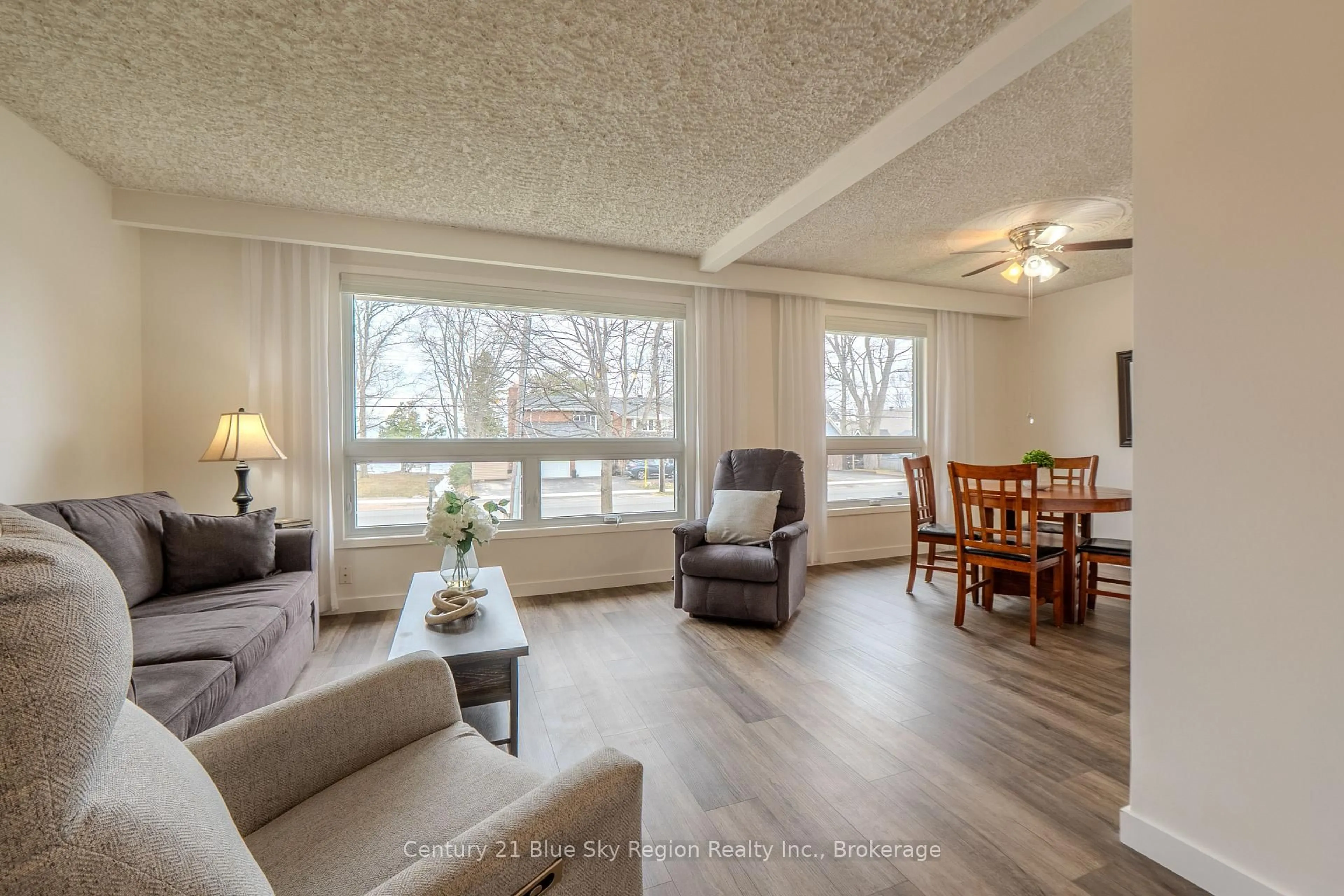 Living room with furniture, wood/laminate floor for 1064 Premier Rd, North Bay Ontario P1A 2J1