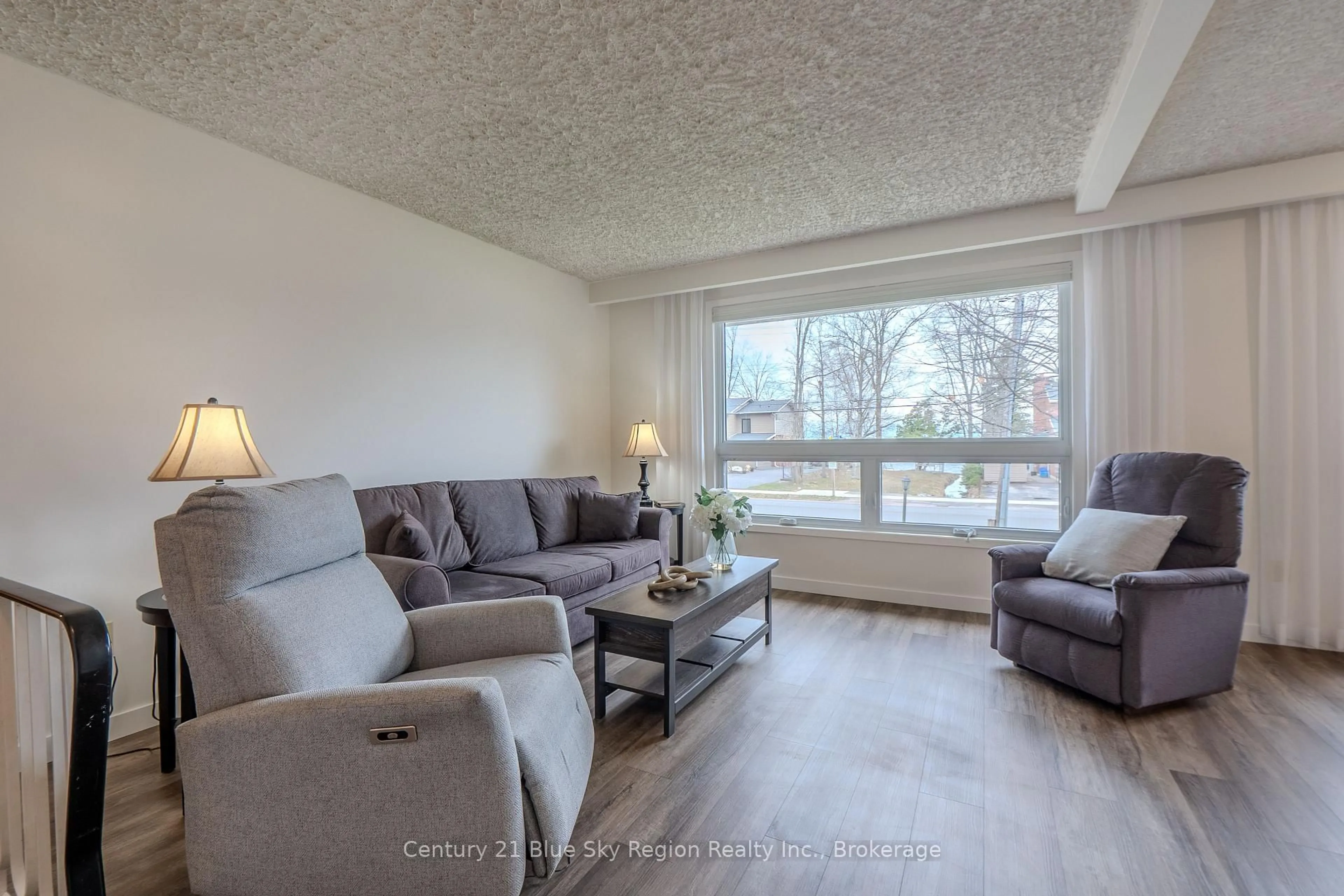 Living room with furniture, wood/laminate floor for 1064 Premier Rd, North Bay Ontario P1A 2J1