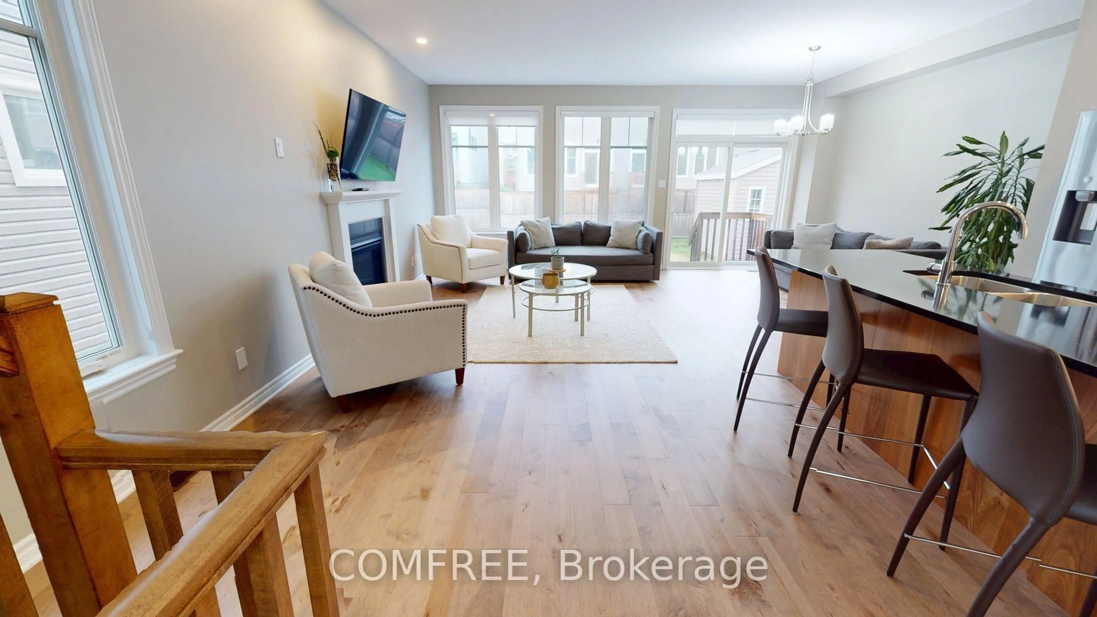 Living room with furniture, wood/laminate floor for 881 Antonio Farley St, Orleans Ontario K4A 5K1