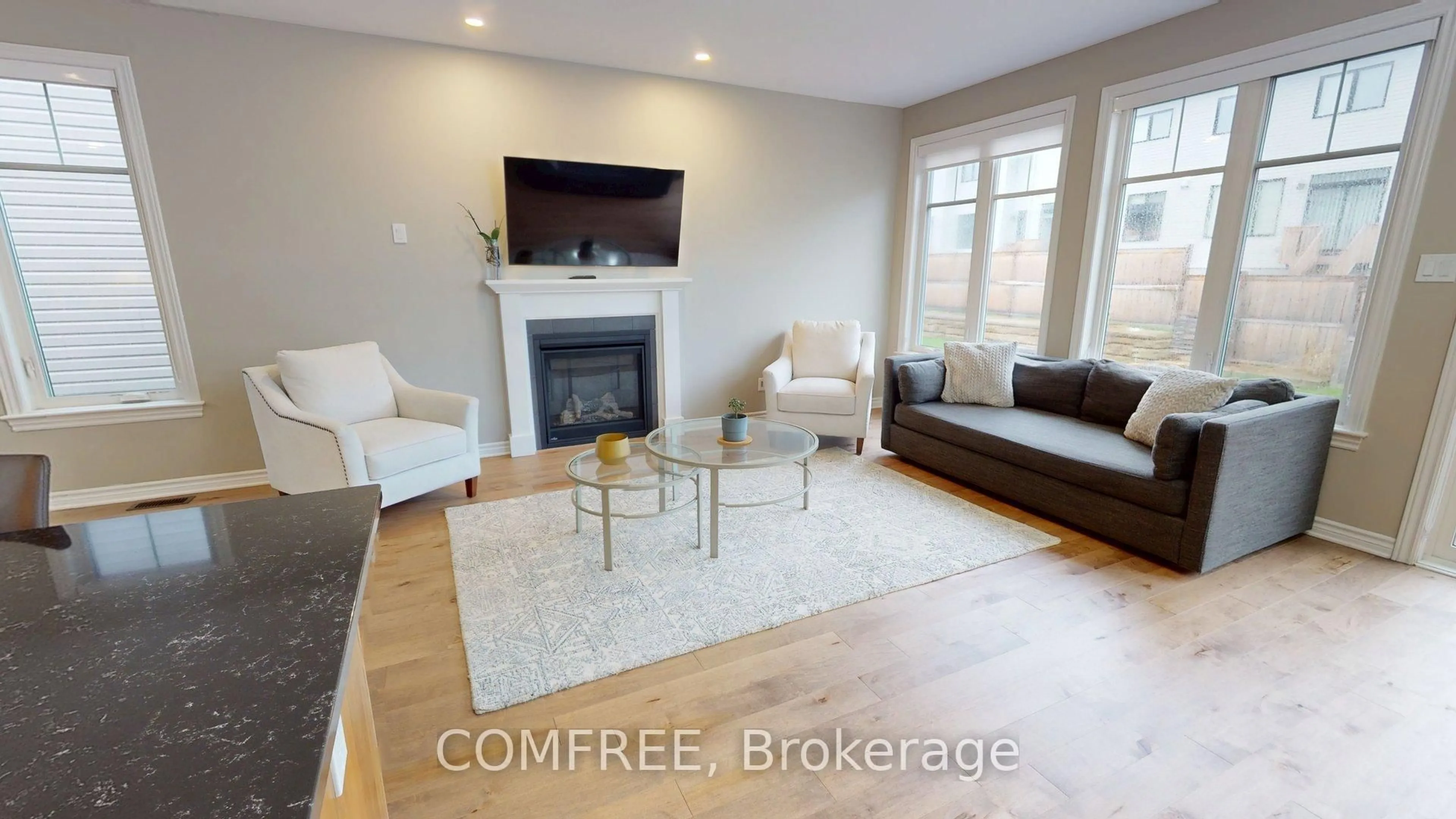Living room with furniture, wood/laminate floor for 881 Antonio Farley St, Orleans Ontario K4A 5K1