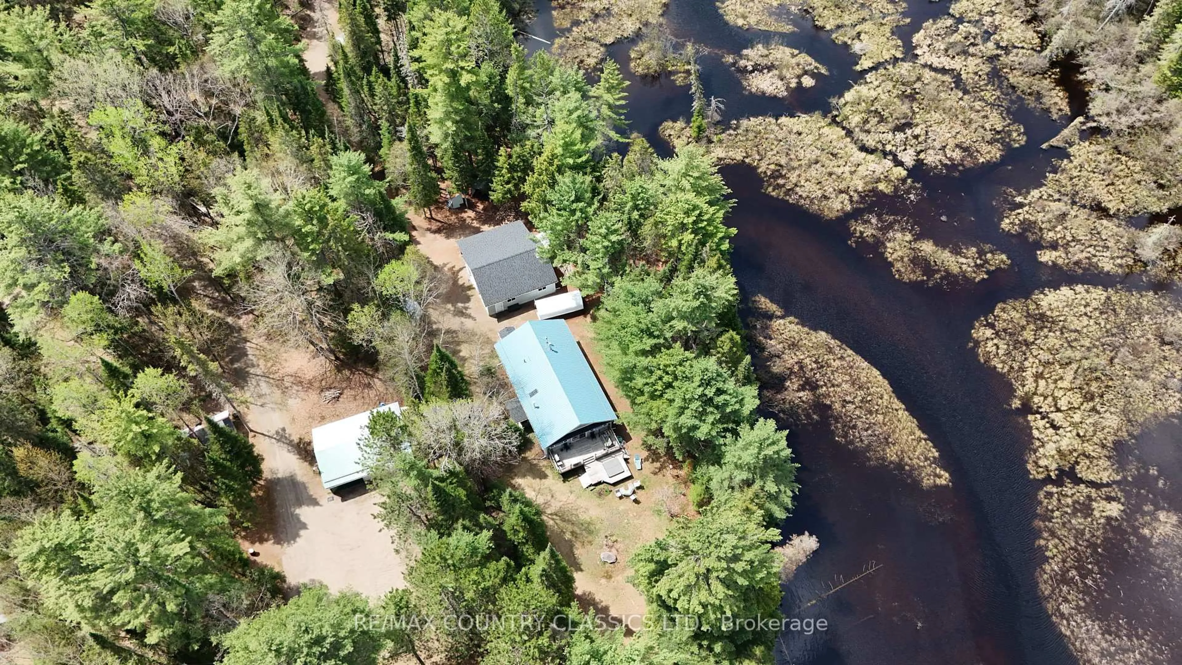 A pic from outside/outdoor area/front of a property/back of a property/a pic from drone, water/lake/river/ocean view for 4501 Elephant Lake Rd, Dysart et al Ontario K0L 2A0