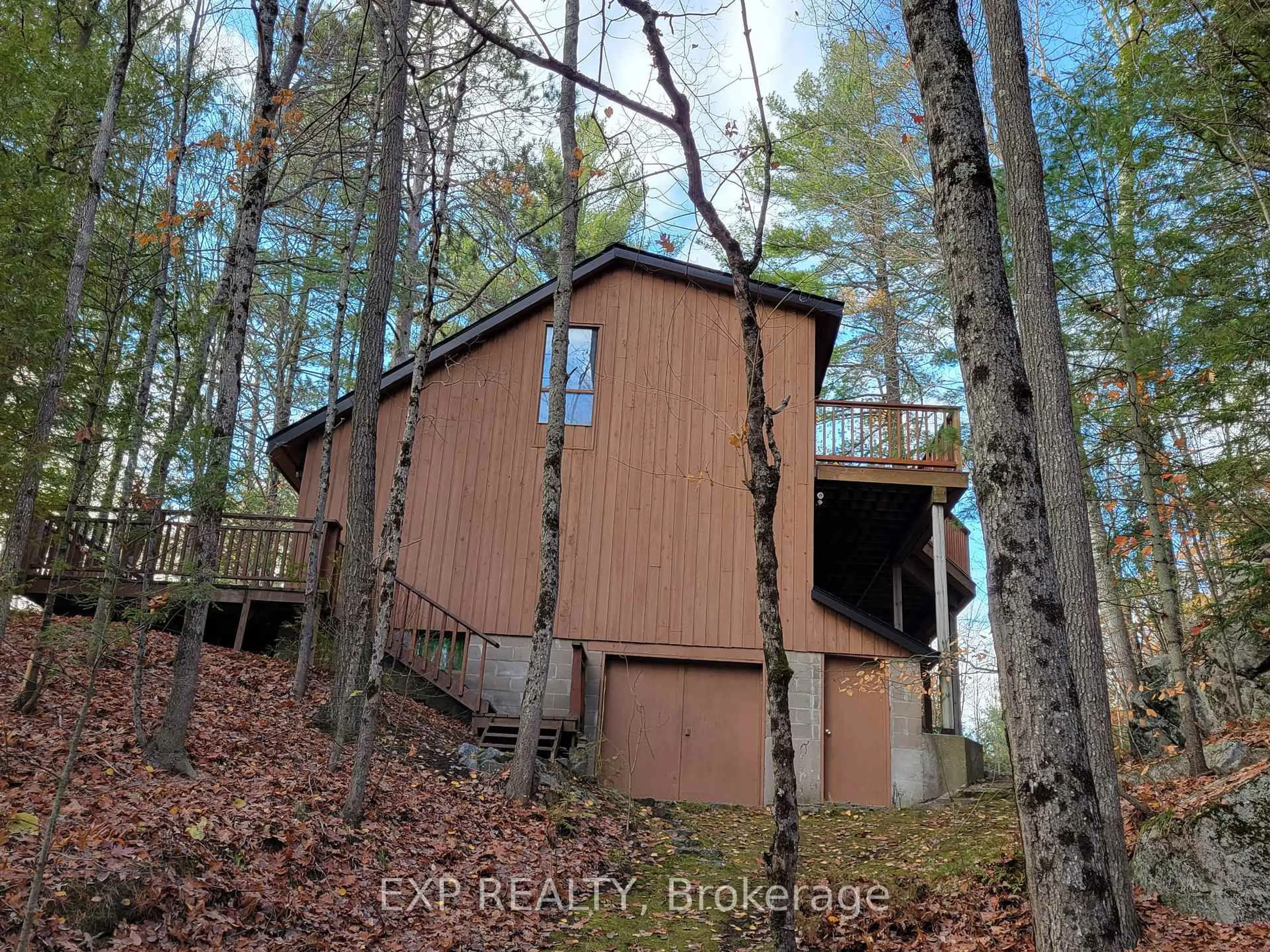 A pic from outside/outdoor area/front of a property/back of a property/a pic from drone, forest/trees view for 71 Quail Lane, North Kawartha Ontario K1L 1A0
