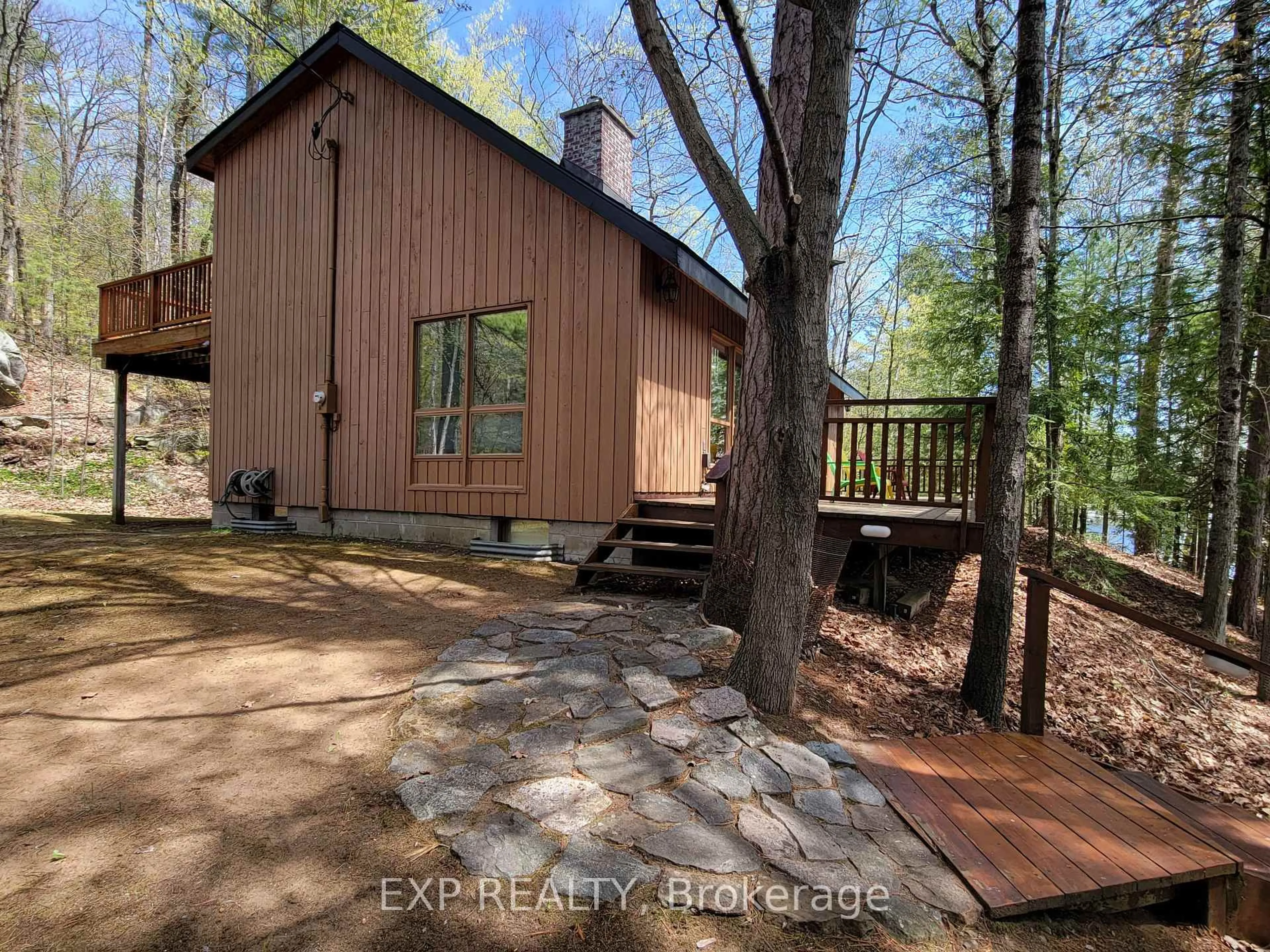 A pic from outside/outdoor area/front of a property/back of a property/a pic from drone, forest/trees view for 71 Quail Lane, North Kawartha Ontario K1L 1A0