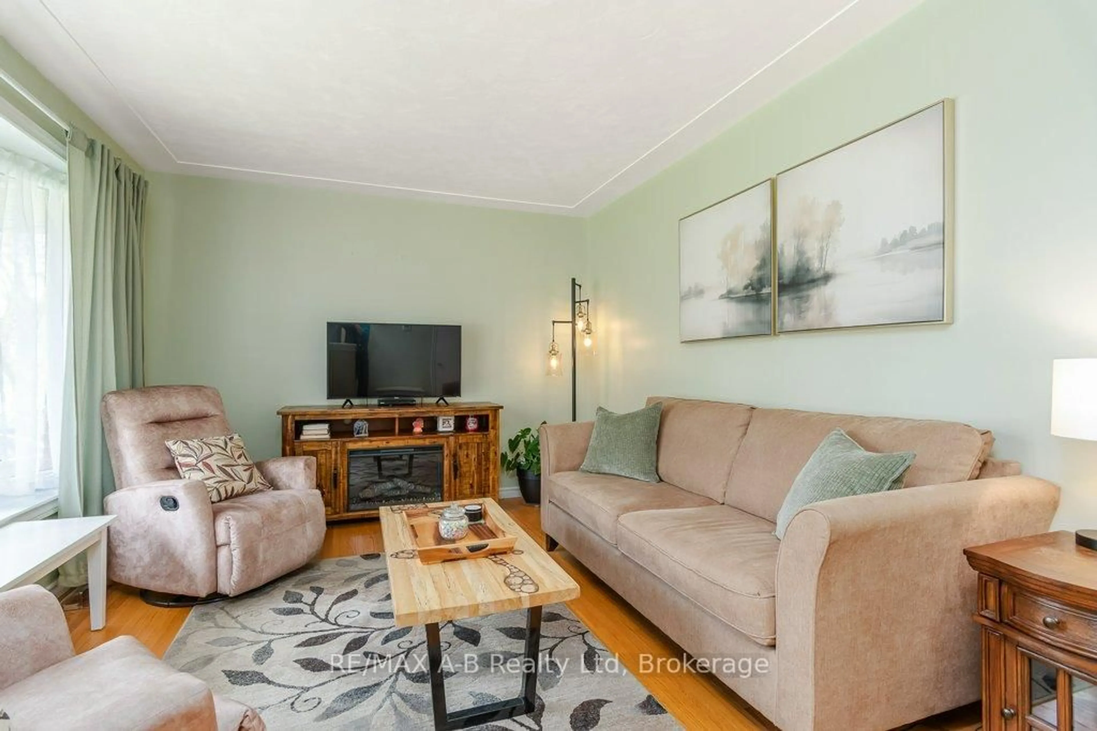 Living room with furniture, wood/laminate floor for 61 Mc Donald St, Stratford Ontario N5A 4W4