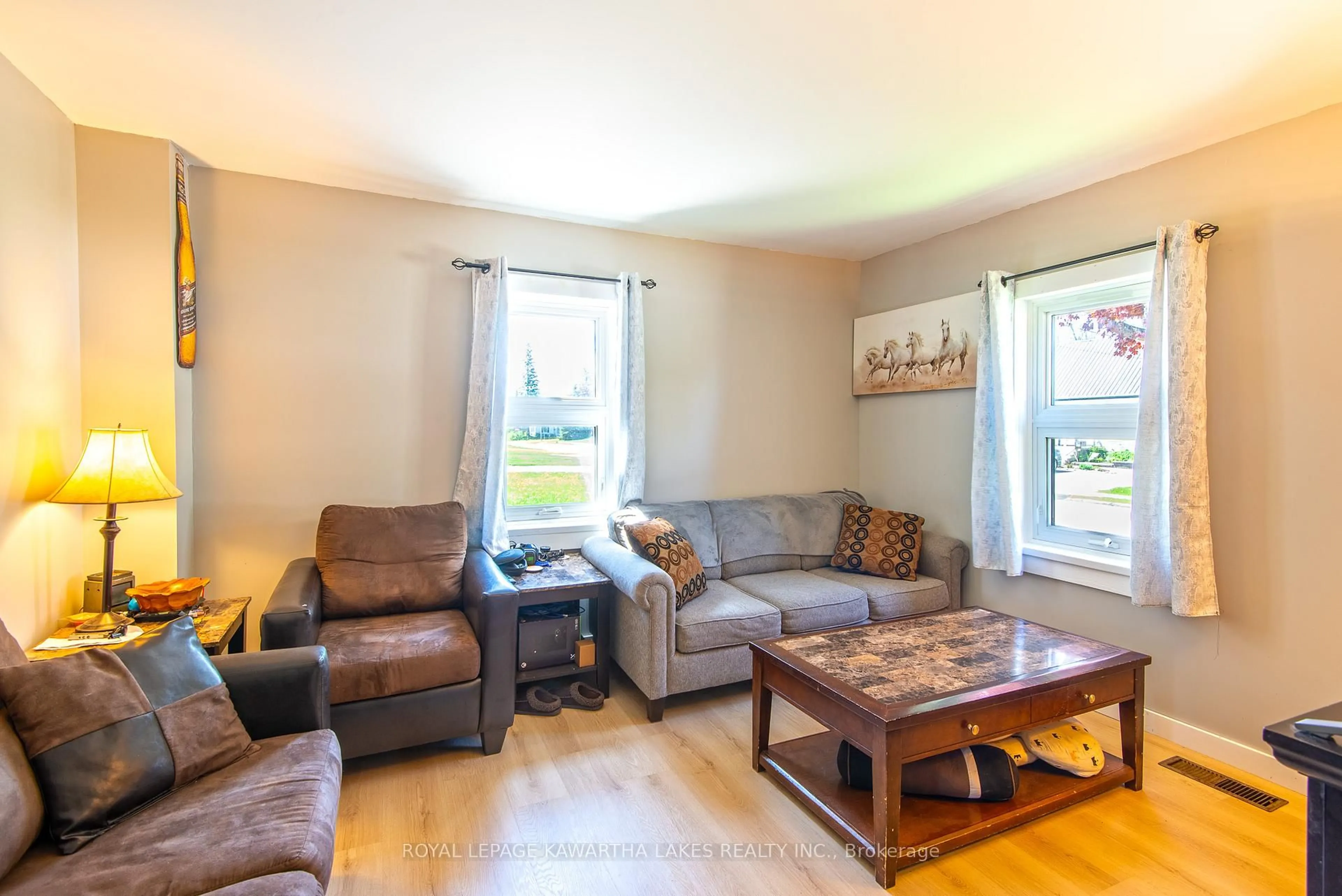 Living room with furniture, wood/laminate floor for 8 Wolfe St, Kawartha Lakes Ontario K9V 2H9