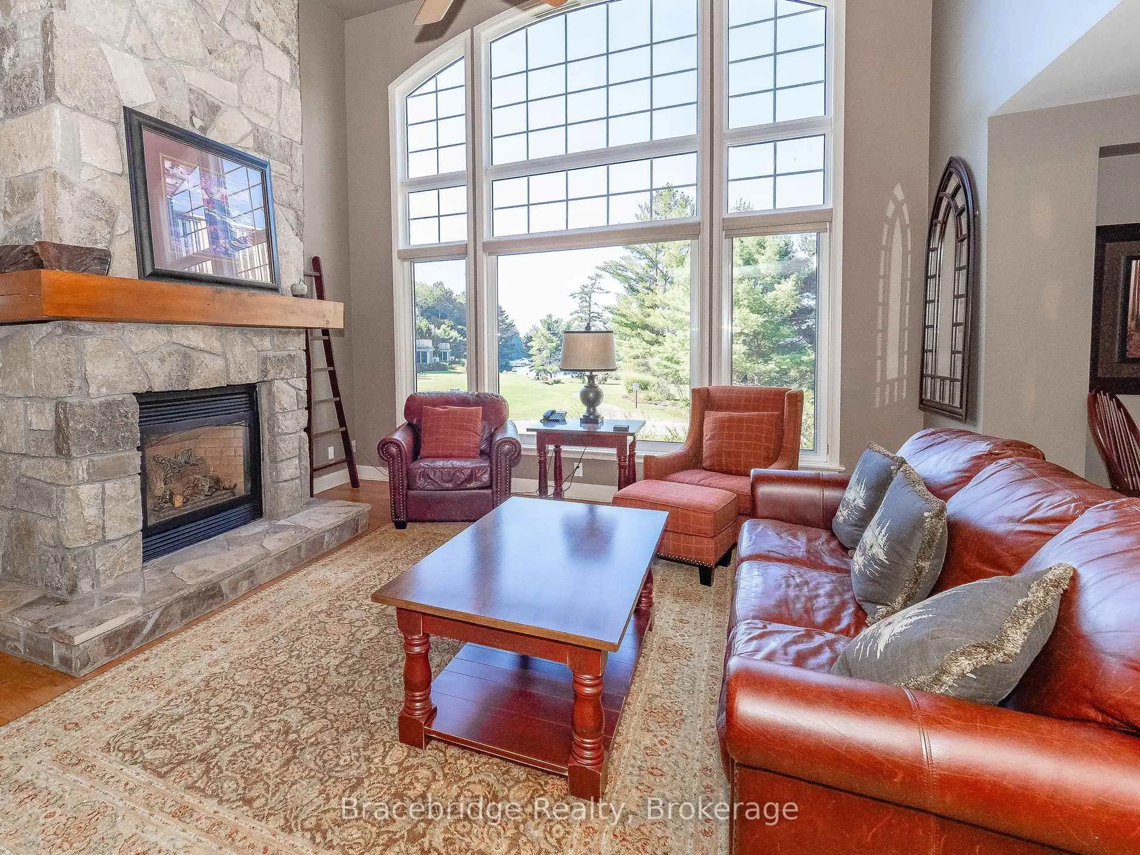 Living room with furniture, ceramic/tile floor for 3876 Muskoka Rd 118 Highway #Sandfield 8 W4, Muskoka Lakes Ontario P0B 1J0