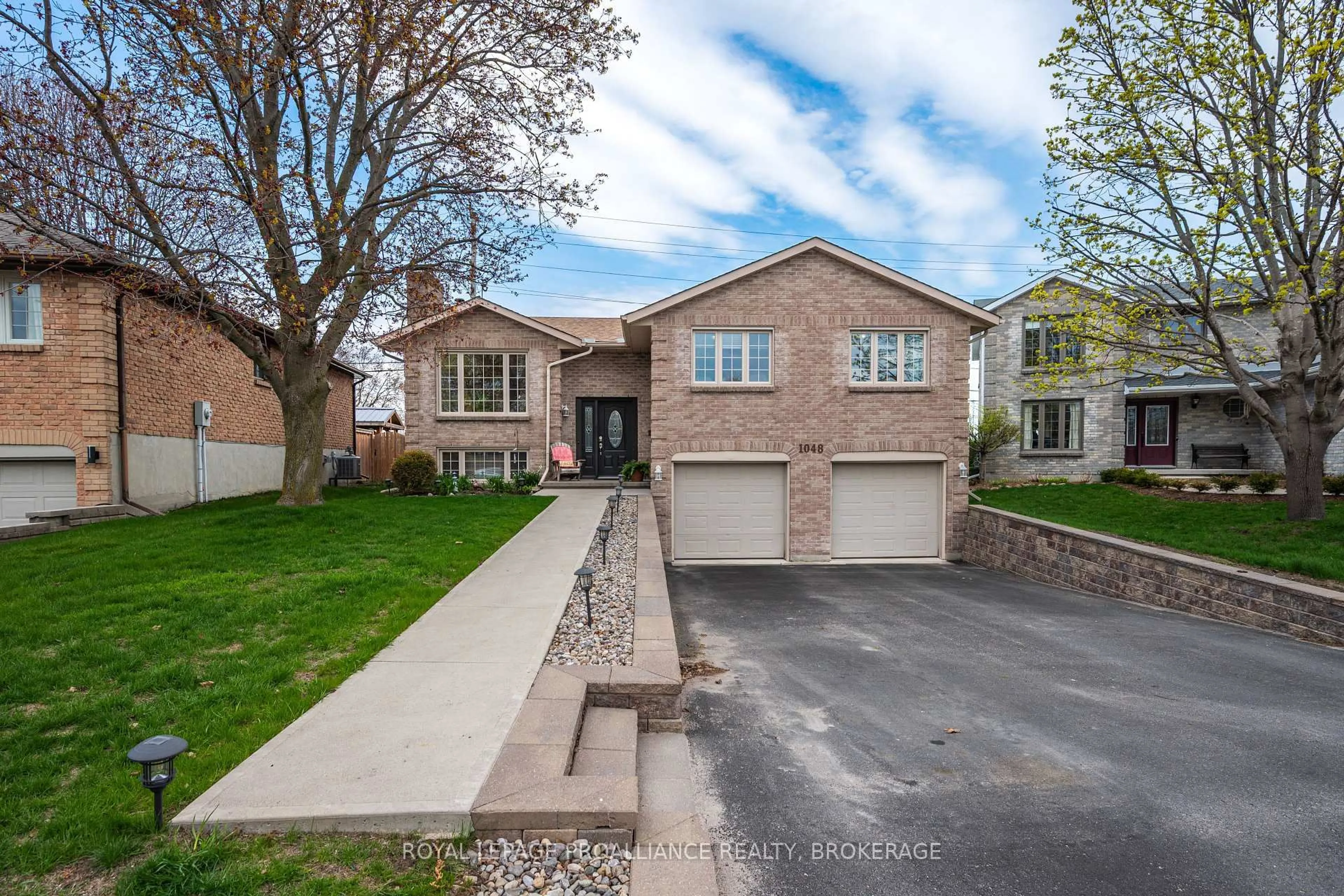 Home with brick exterior material, street for 1048 Palmerston Cres, Kingston Ontario K7P 2P5