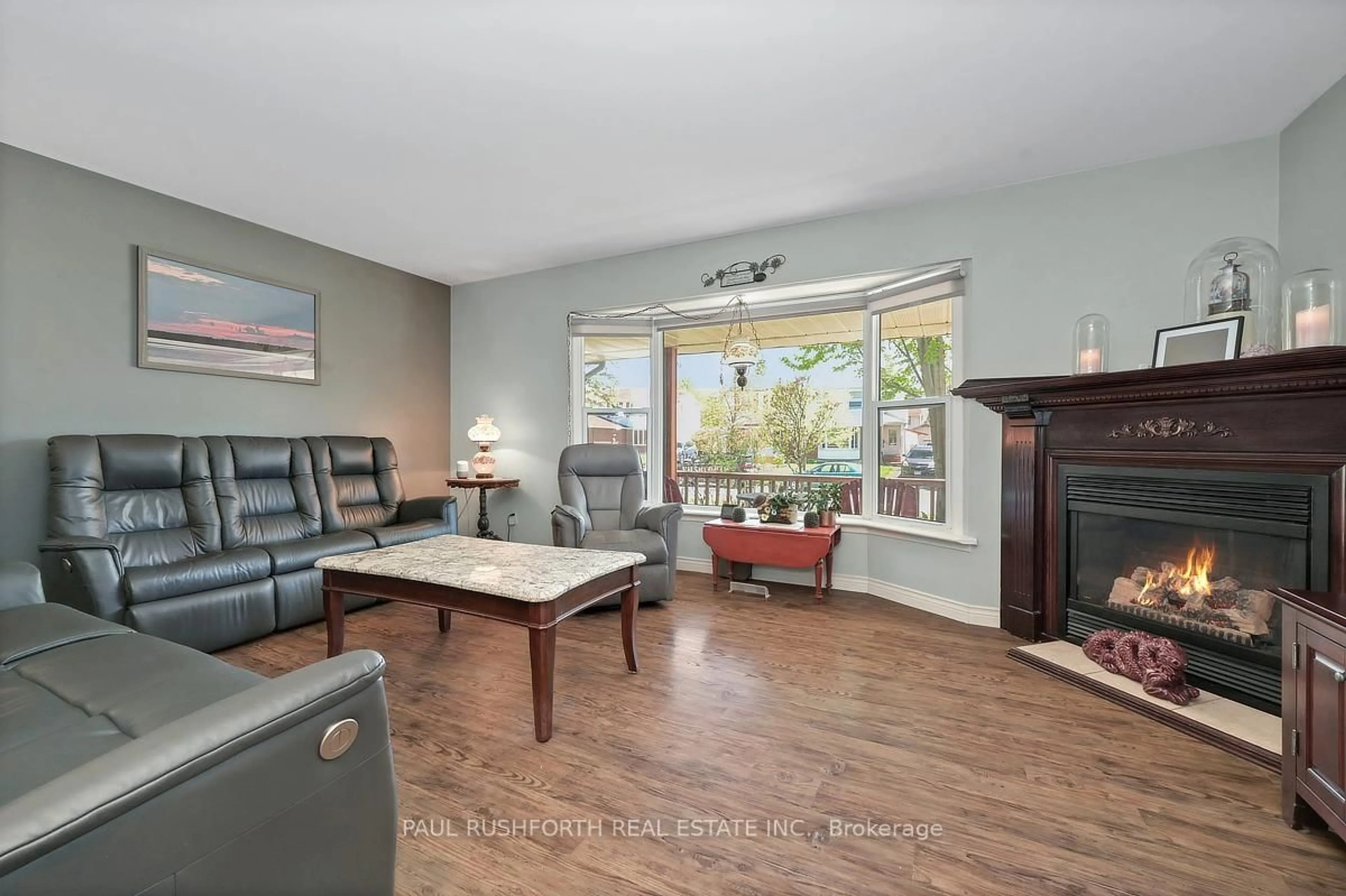 Living room with furniture, wood/laminate floor for 25 Seabrooke Dr, Ottawa Ontario K2L 2H8