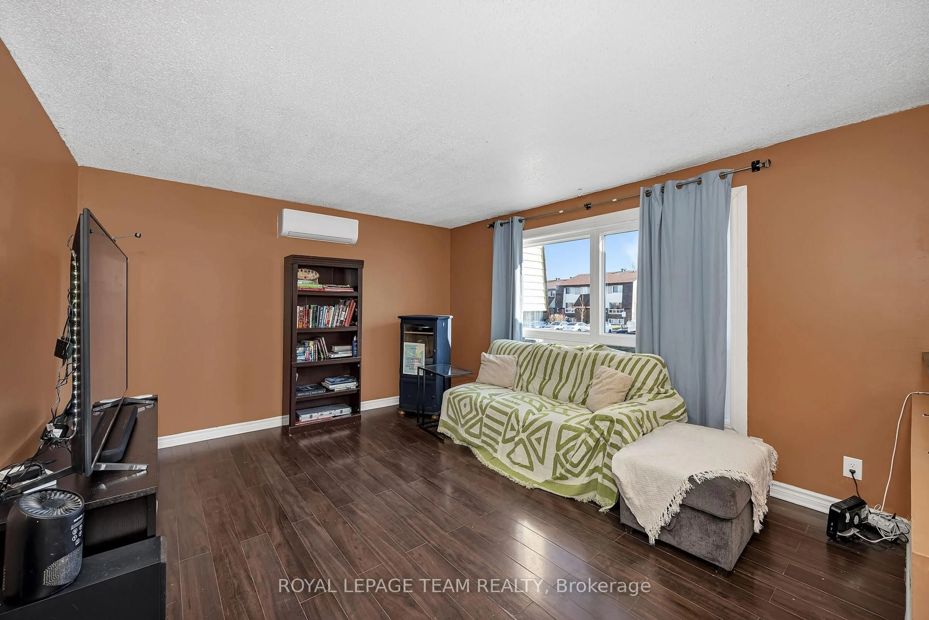 Living room with furniture, wood/laminate floor for 23A Woodvale Green, Ottawa Ontario K2G 4H3