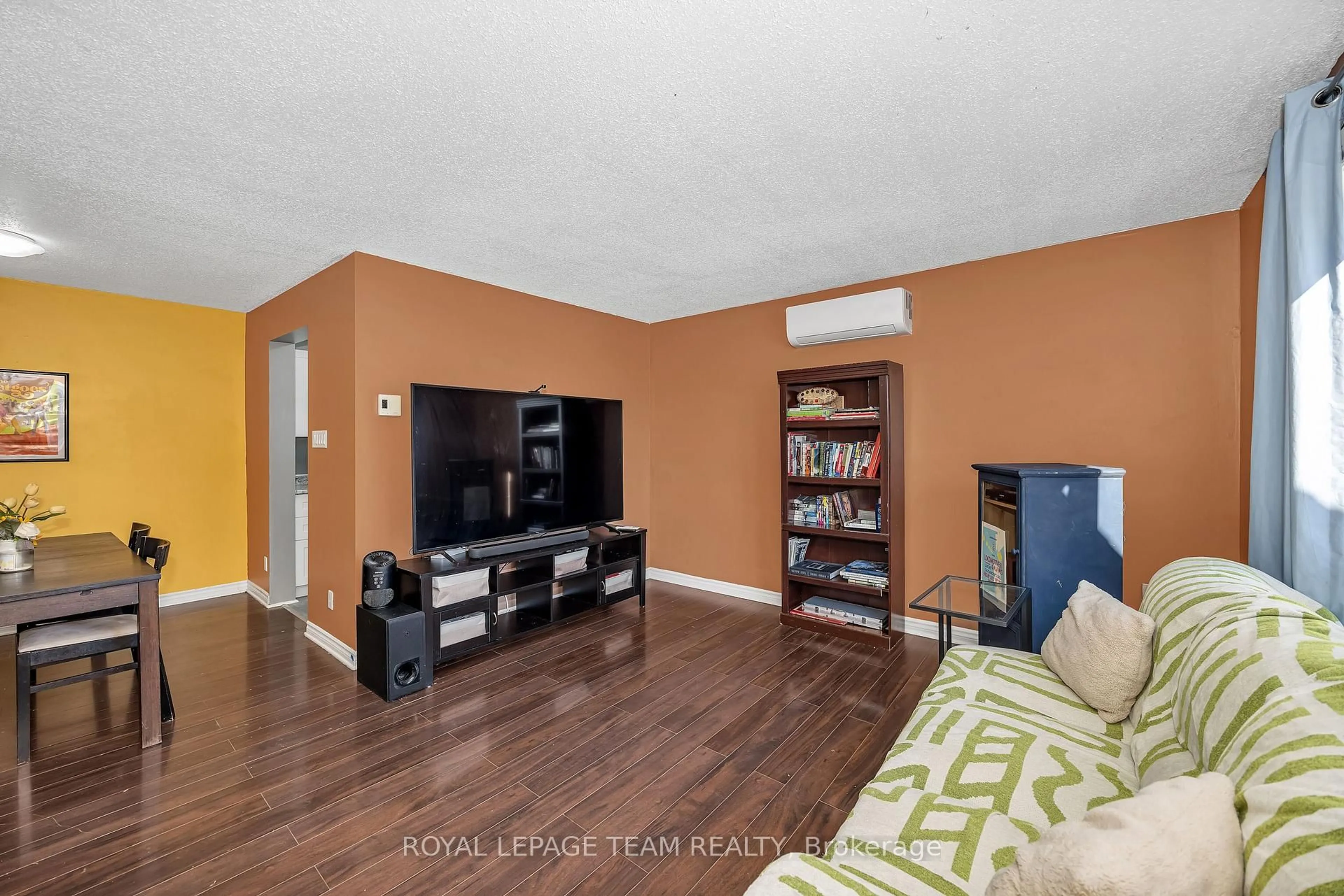 Living room with furniture, wood/laminate floor for 23A Woodvale Green, Ottawa Ontario K2G 4H3