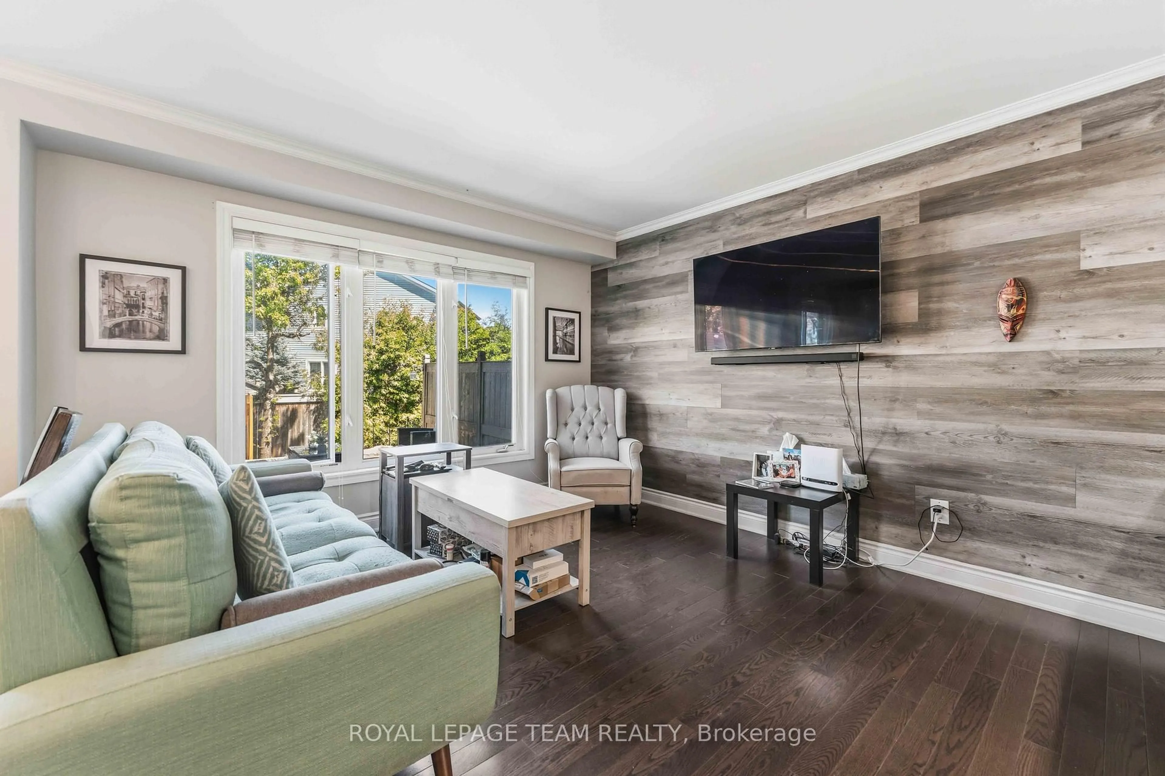 Living room with furniture, wood/laminate floor for 231 Cayman Rd, Ottawa Ontario K2S 0N8