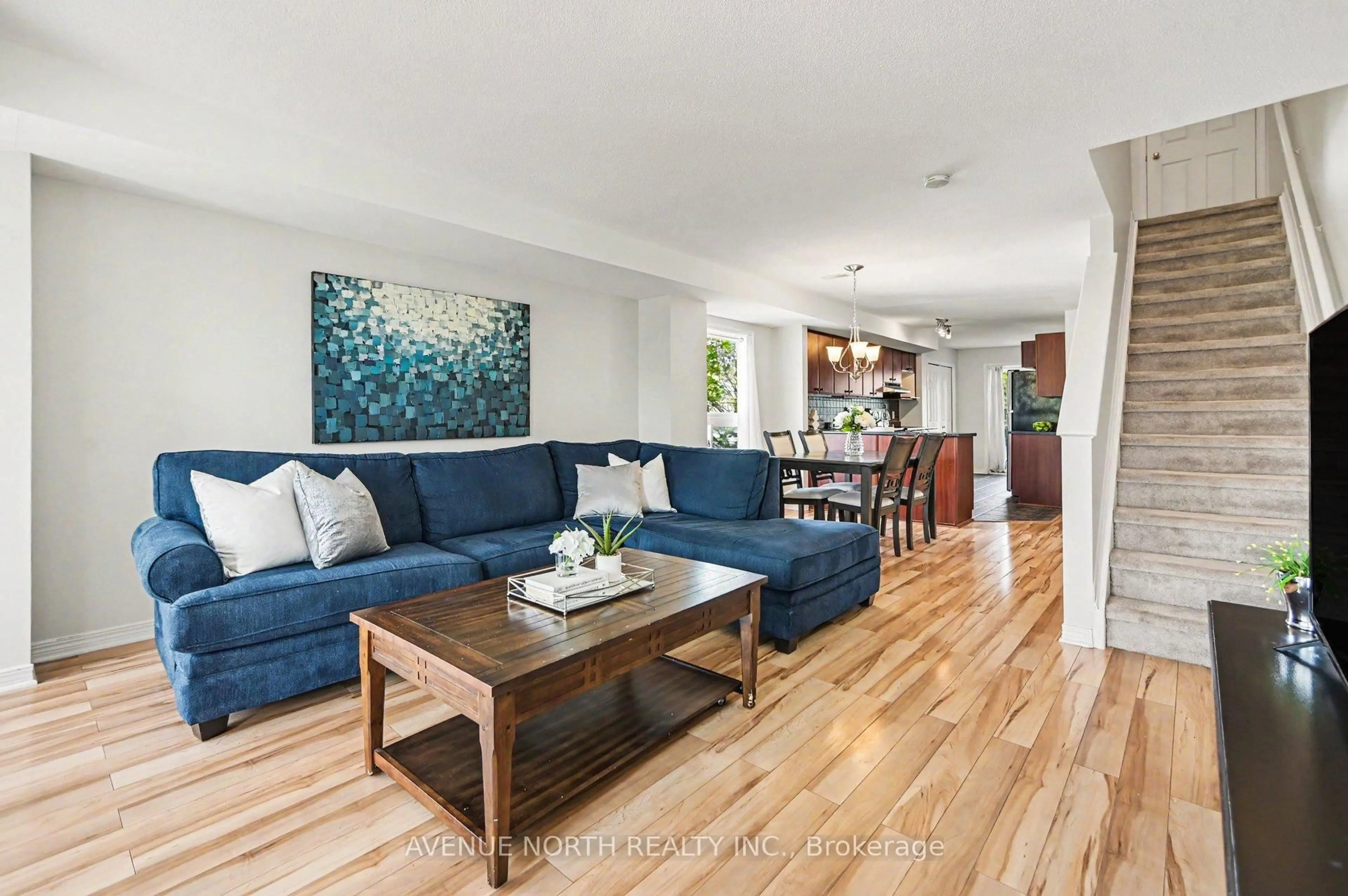 Living room with furniture, wood/laminate floor for 130 Berrigan Dr #88, Ottawa Ontario K2J 0J3