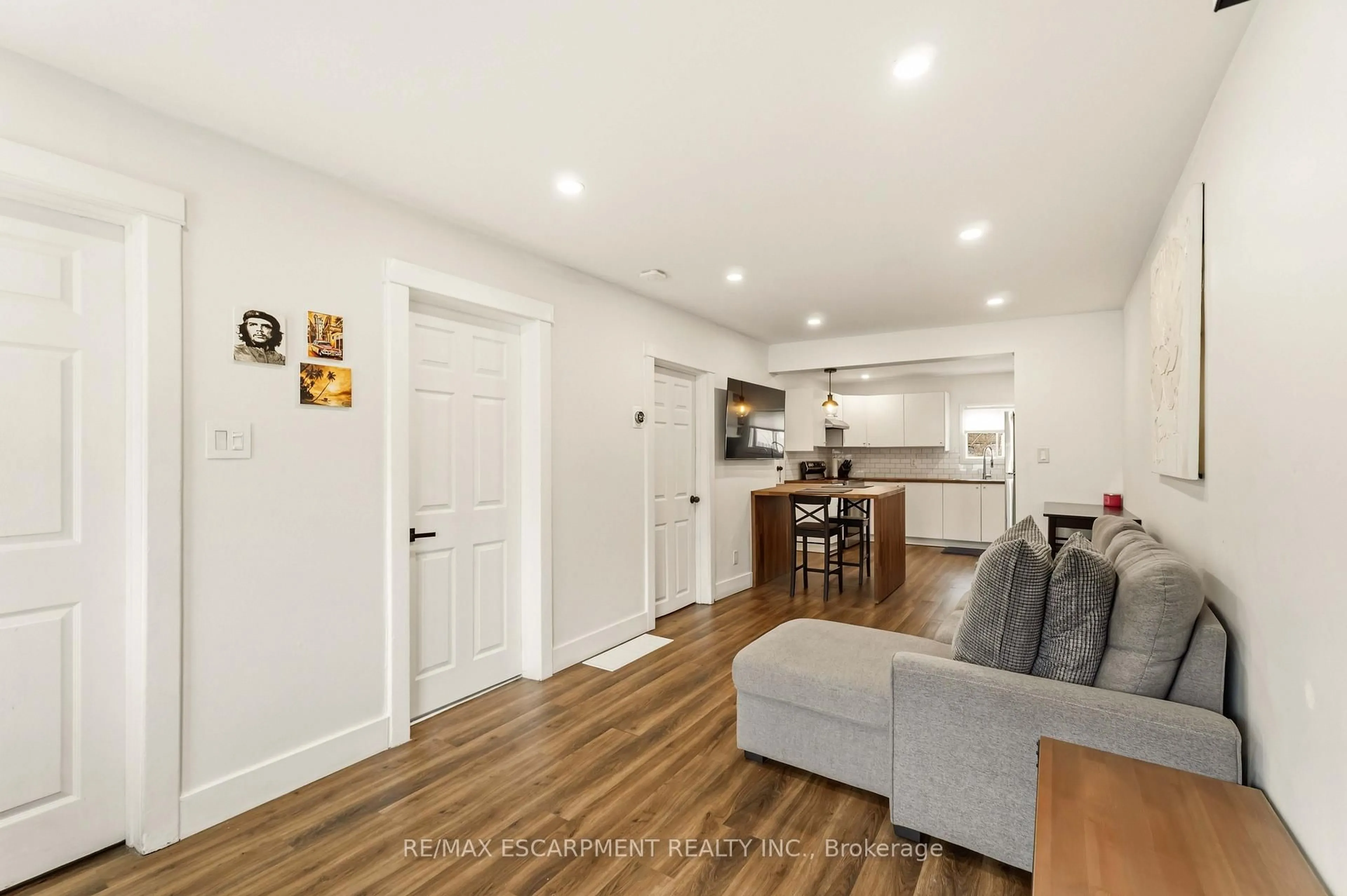 Open concept kitchen, wood/laminate floor for 27 Edinburgh Ave, Hamilton Ontario L8H 2C4