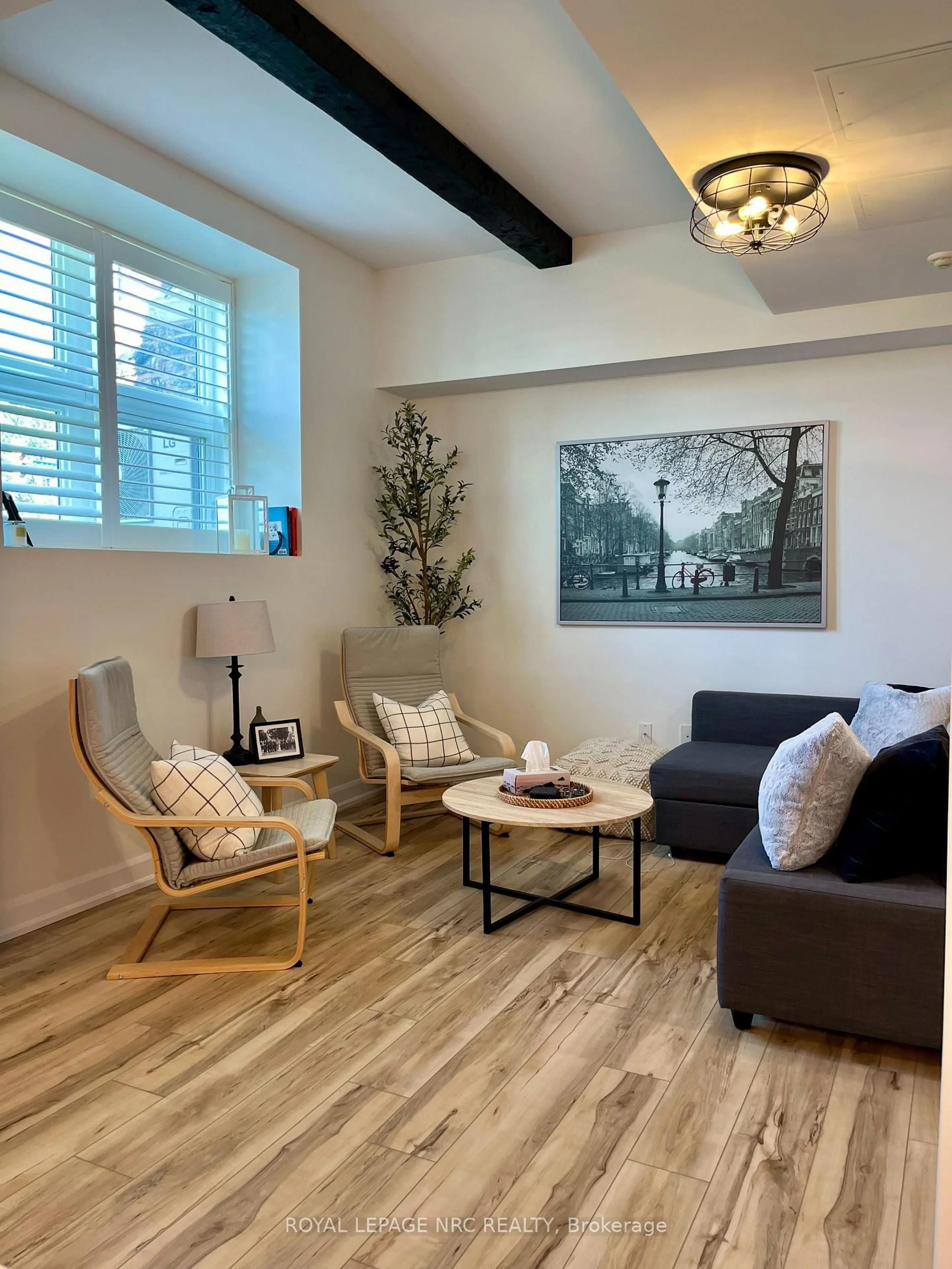 Living room with furniture, wood/laminate floor for 405 Merritt St #7, St. Catharines Ontario L2P 1P5