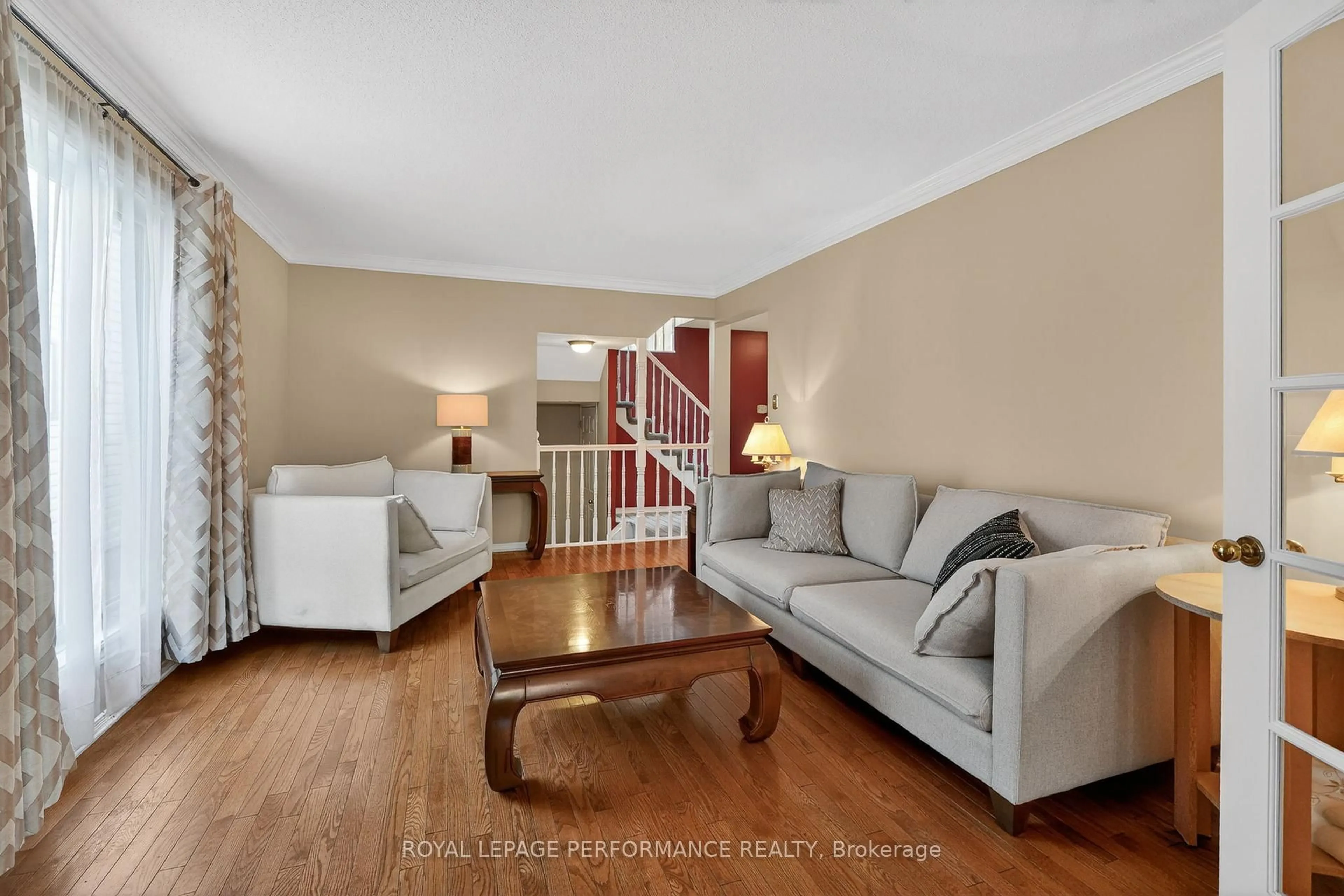 Living room with furniture, wood/laminate floor for 6592 Windsong Ave, Orleans Ontario K1C 6M9
