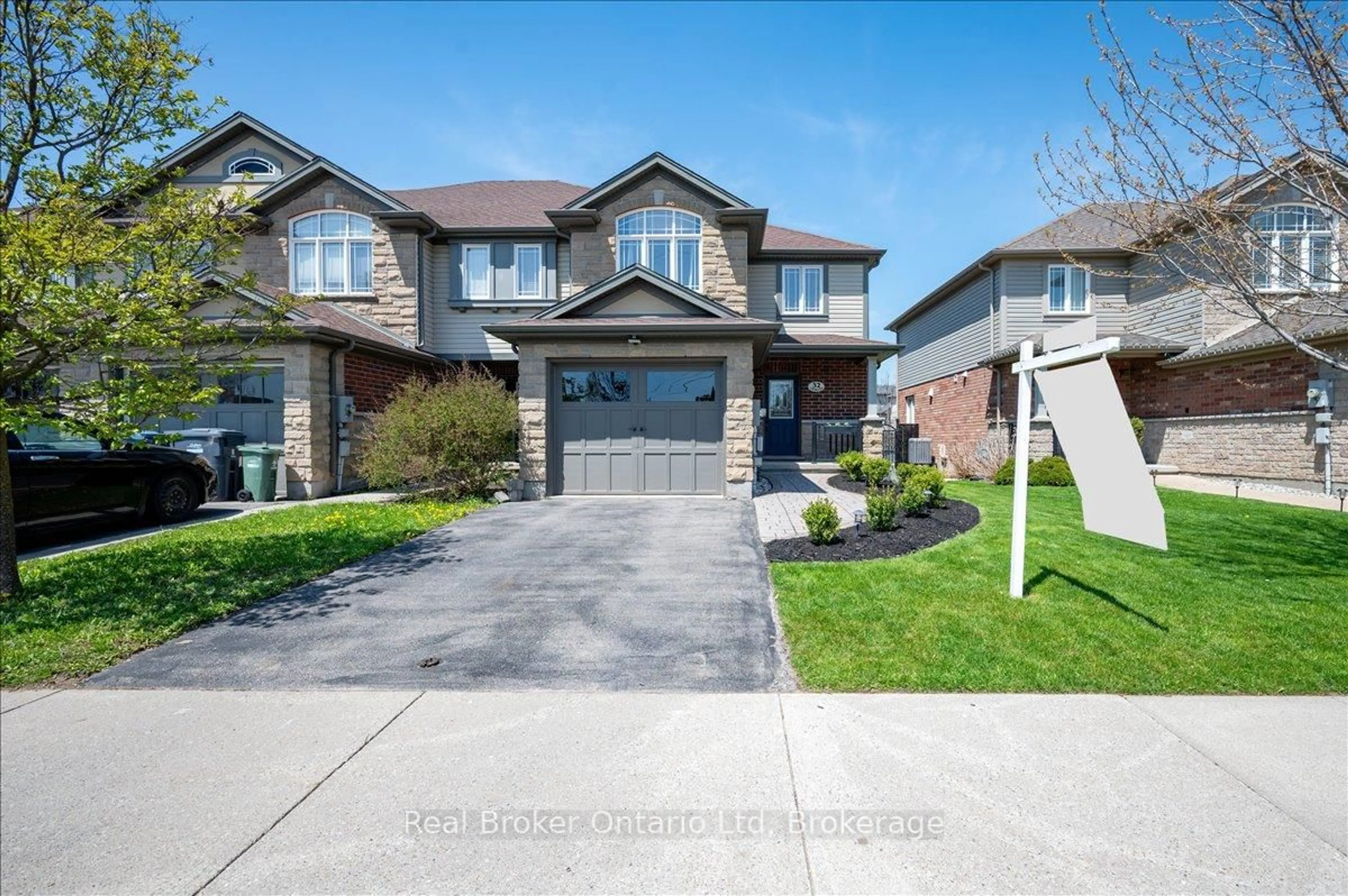 Home with brick exterior material, street for 32 Laughland Lane, Guelph Ontario N1L 0C9