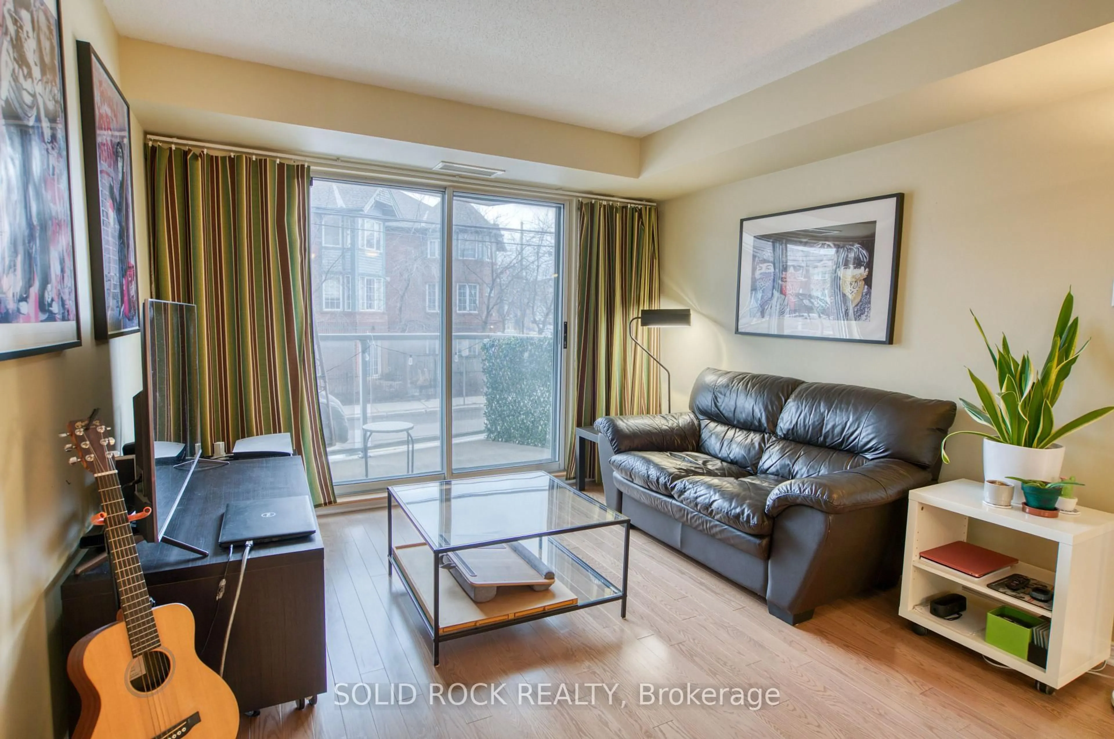 Living room with furniture, wood/laminate floor for 429 Somerset St #209, Ottawa Ontario K2P 2P5