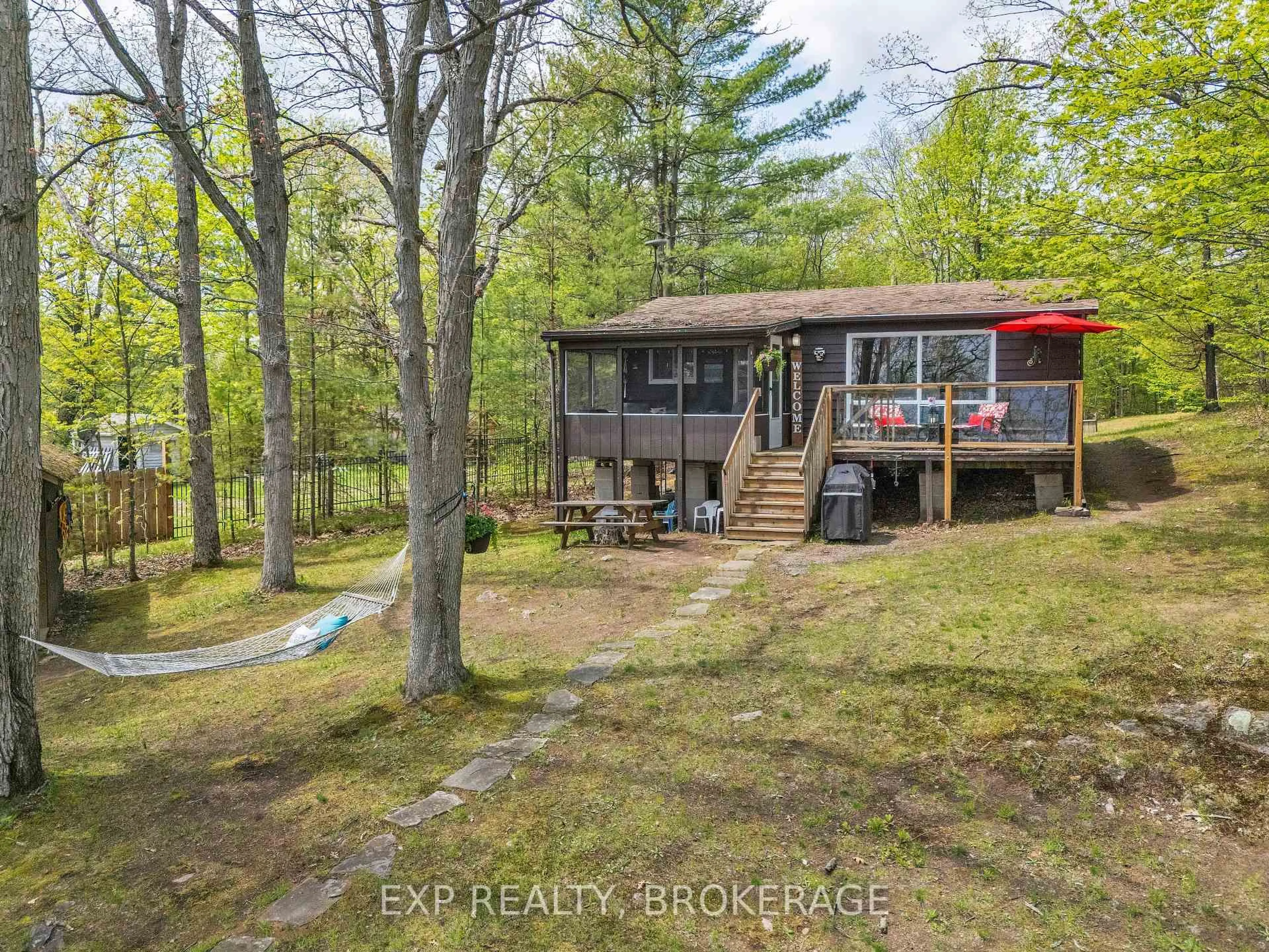 A pic from outside/outdoor area/front of a property/back of a property/a pic from drone, forest/trees view for 3 Acorn Lane, Tichborne Ontario K0H 2V0