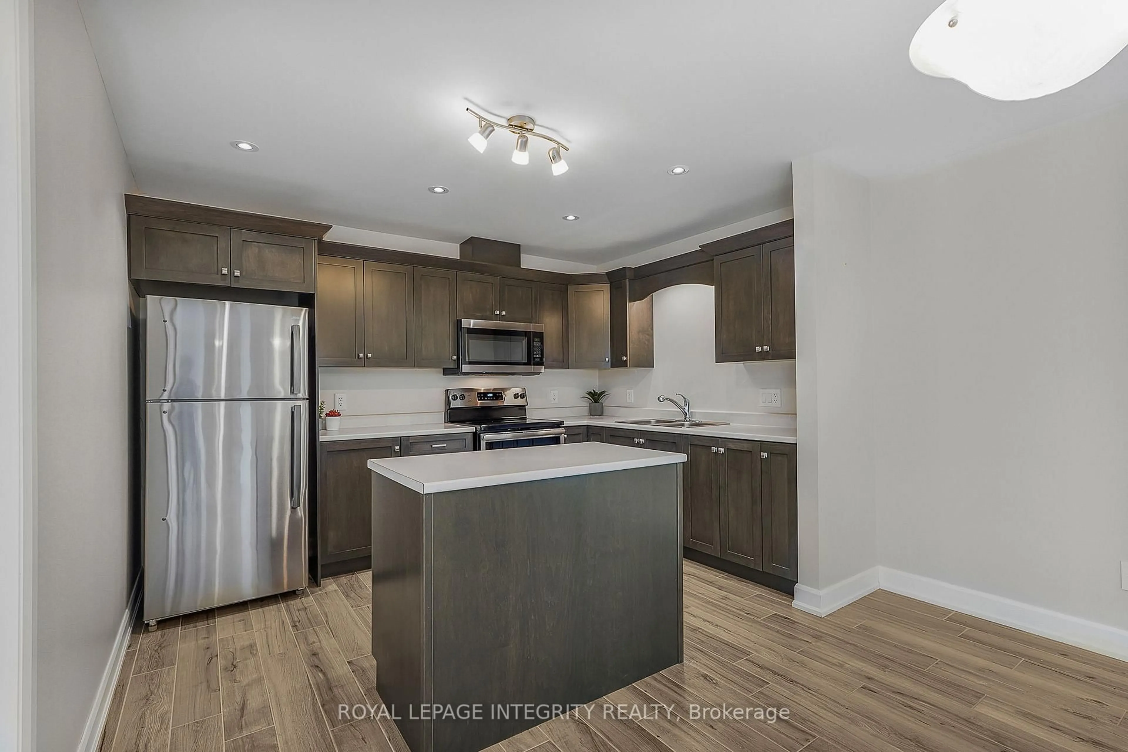 Open concept kitchen, wood/laminate floor for 48 Des Benevoles St #208, The Nation Ontario K0A 2M0