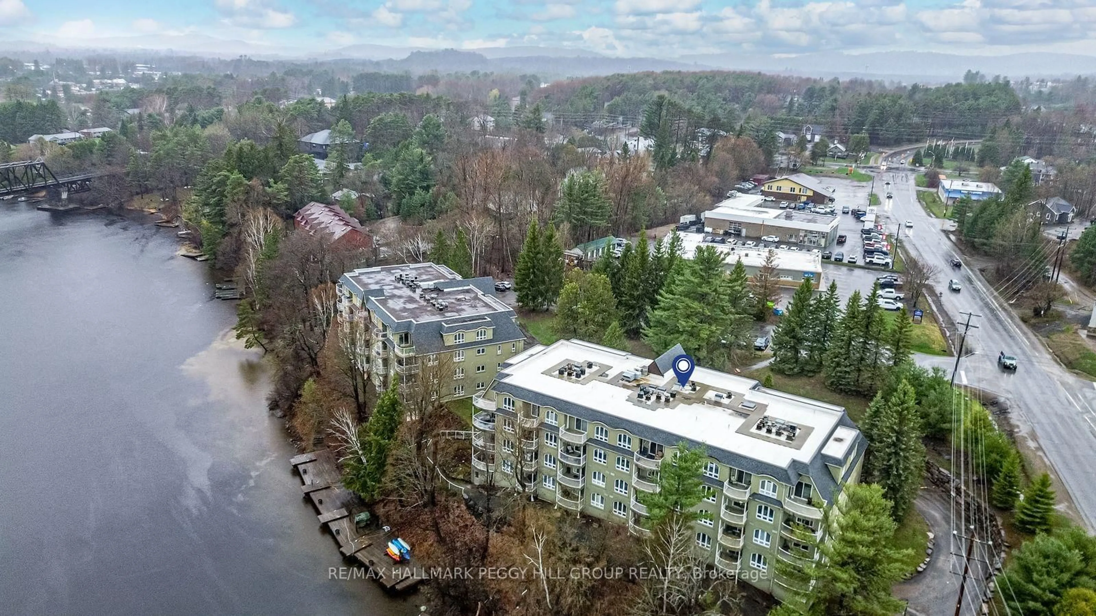 A pic from outside/outdoor area/front of a property/back of a property/a pic from drone, unknown for 31 Dairy Lane #308, Huntsville Ontario P1H 2L7