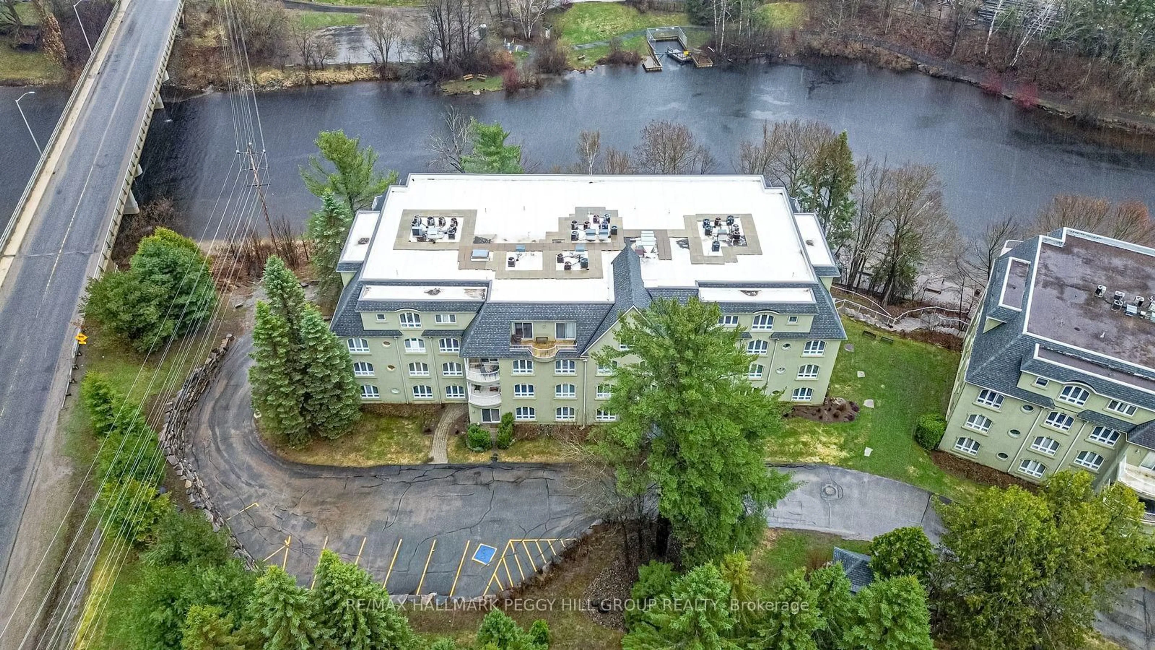 A pic from outside/outdoor area/front of a property/back of a property/a pic from drone, water/lake/river/ocean view for 31 Dairy Lane #308, Huntsville Ontario P1H 2L7