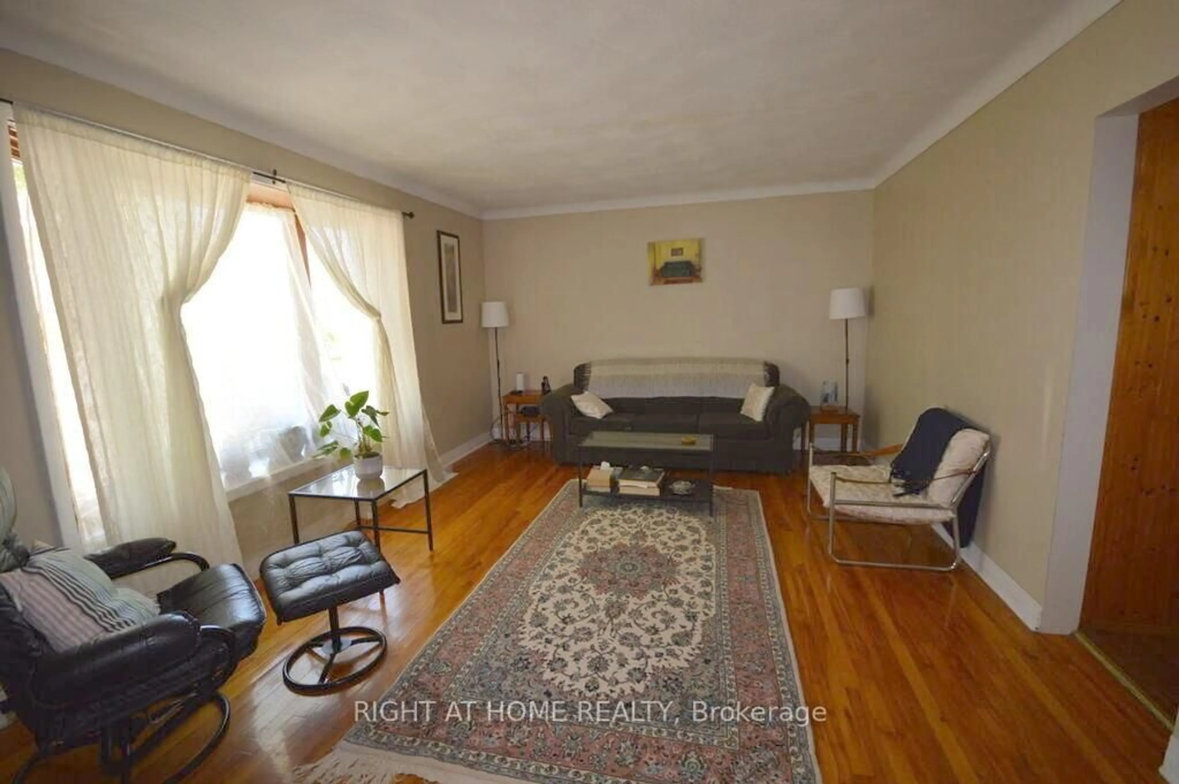 Living room with furniture, wood/laminate floor for 200 Woodroffe Ave, Ottawa Ontario K2A 3V4