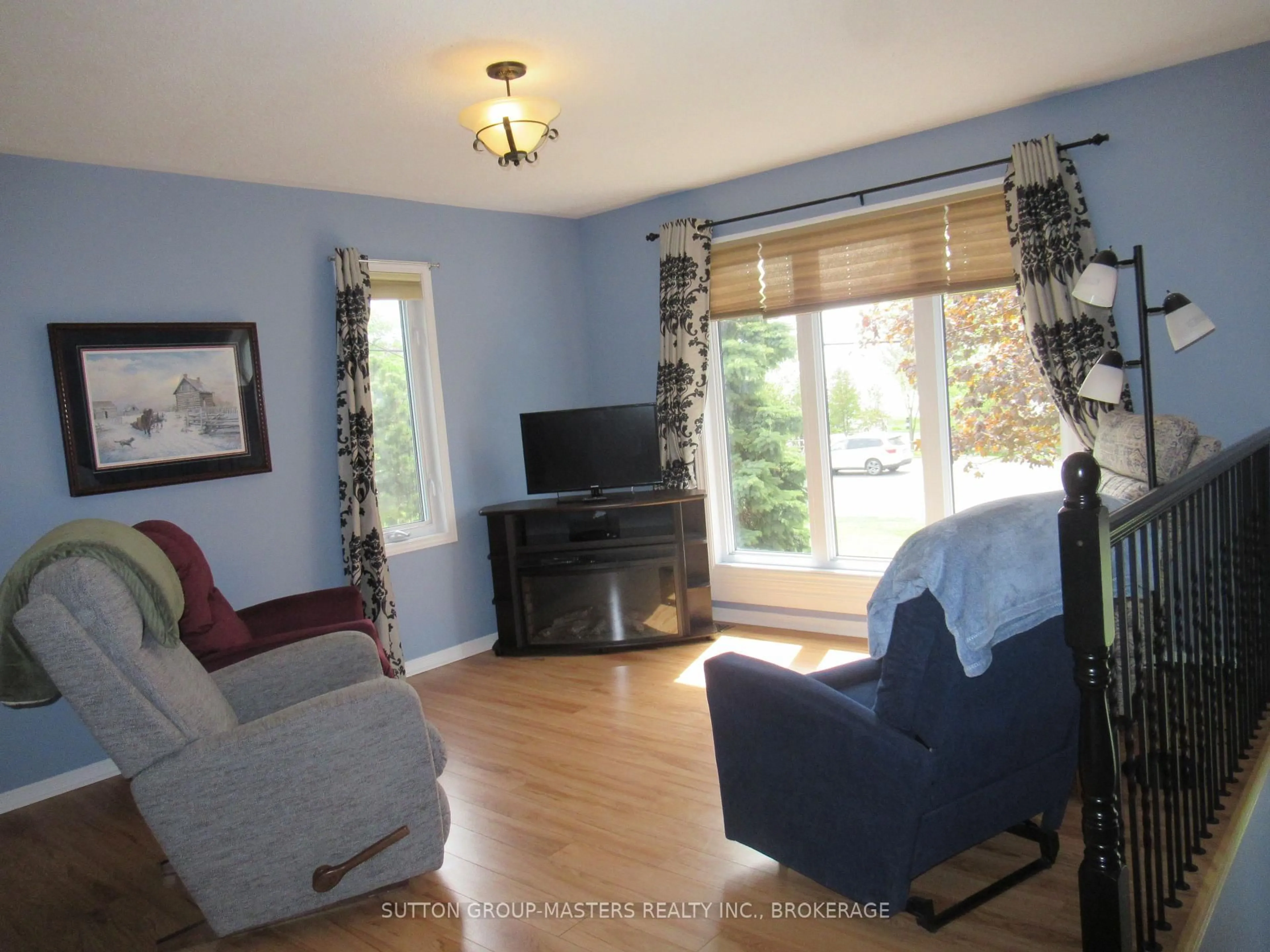 Living room with furniture, wood/laminate floor for 4571 Bath Rd, Loyalist Ontario K7N 1A8