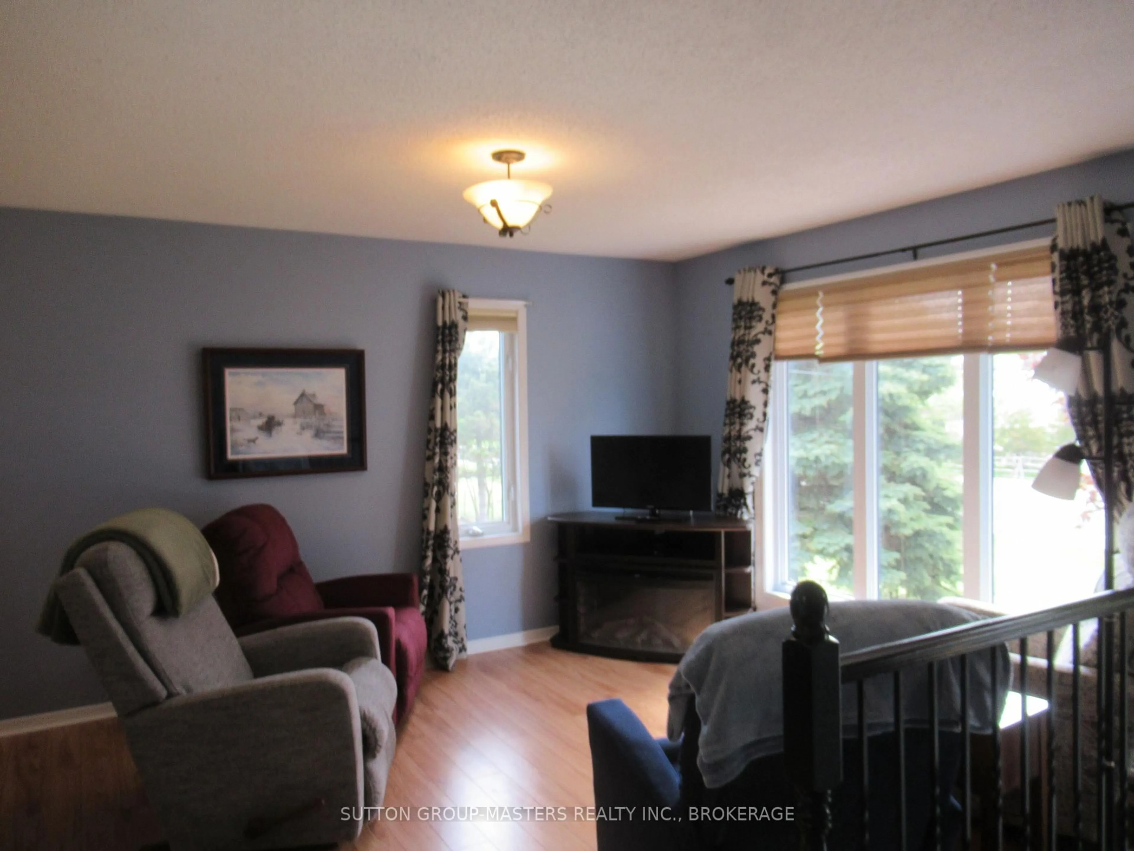 Living room with furniture, wood/laminate floor for 4571 Bath Rd, Loyalist Ontario K7N 1A8