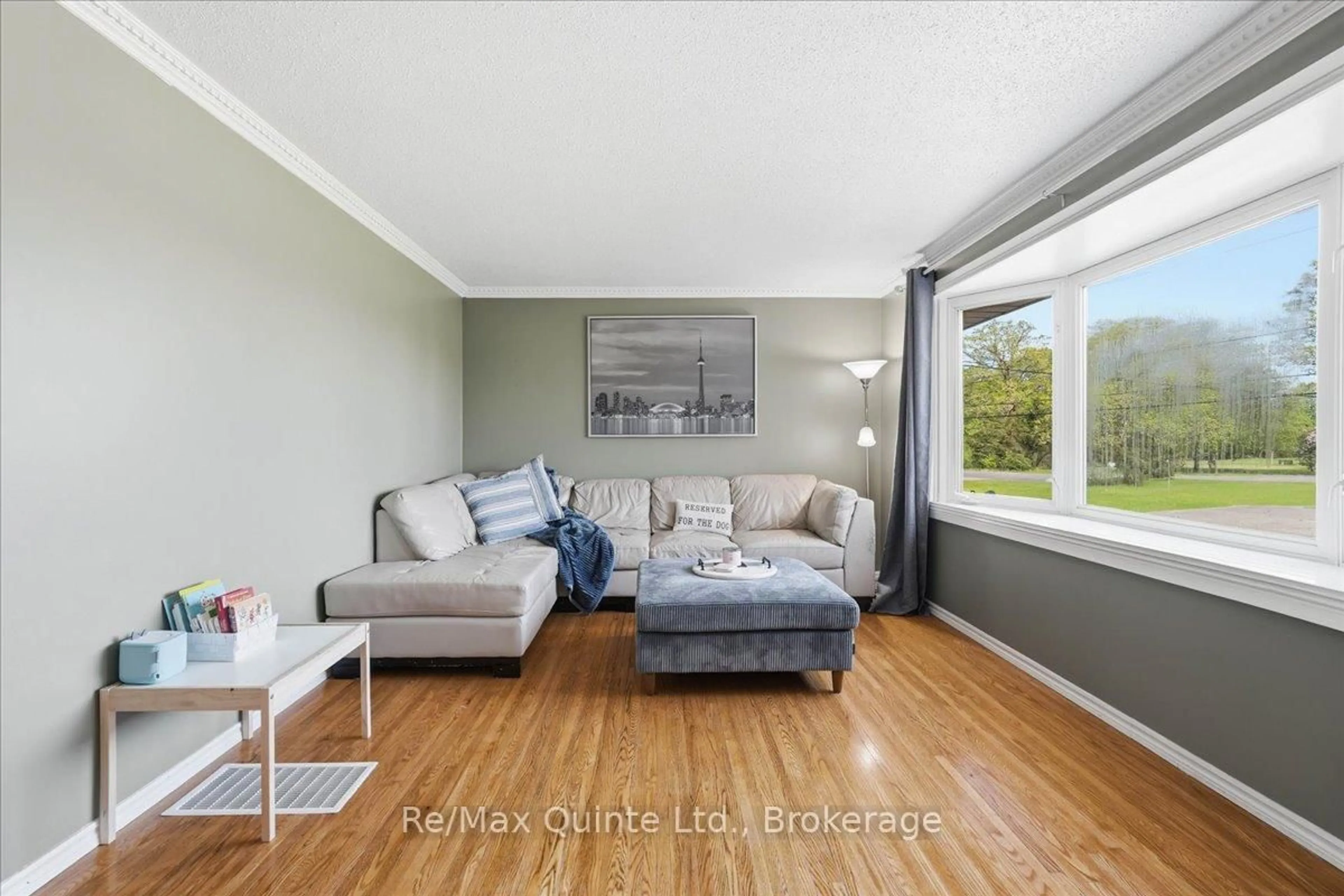 Living room with furniture, wood/laminate floor for 745 Harmony Rd, Corbyville Ontario K0K 1V0