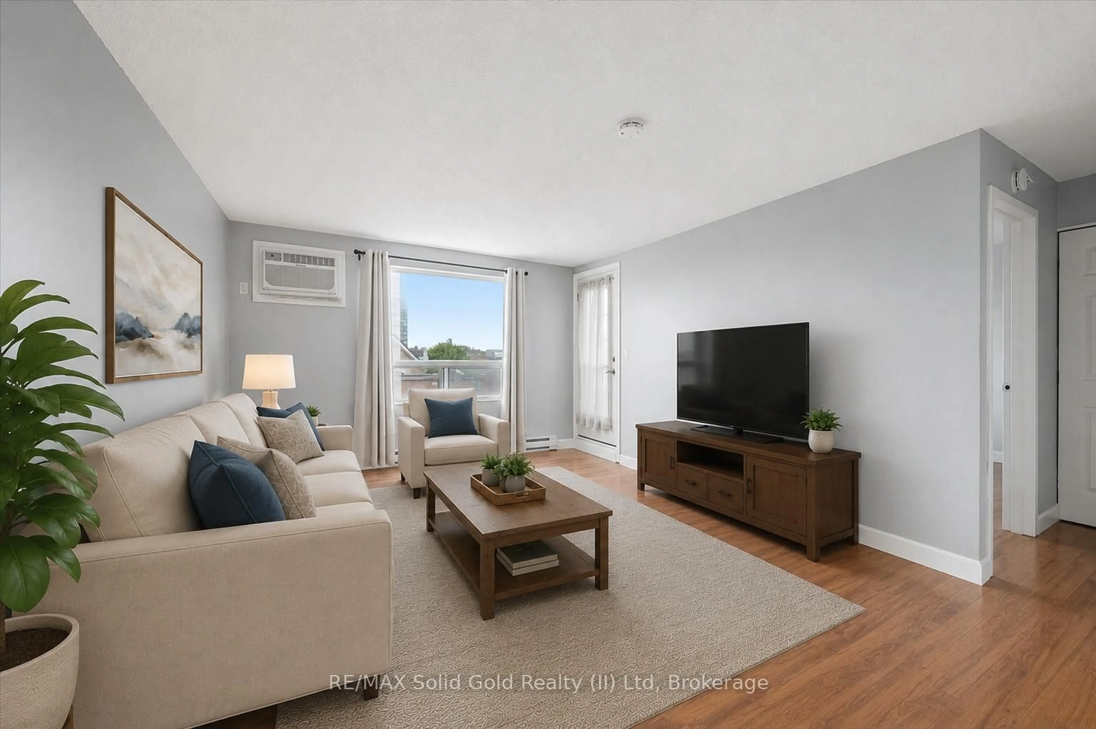 Living room with furniture, wood/laminate floor for 64 Benton St #304, Kitchener Ontario N2G 4L9