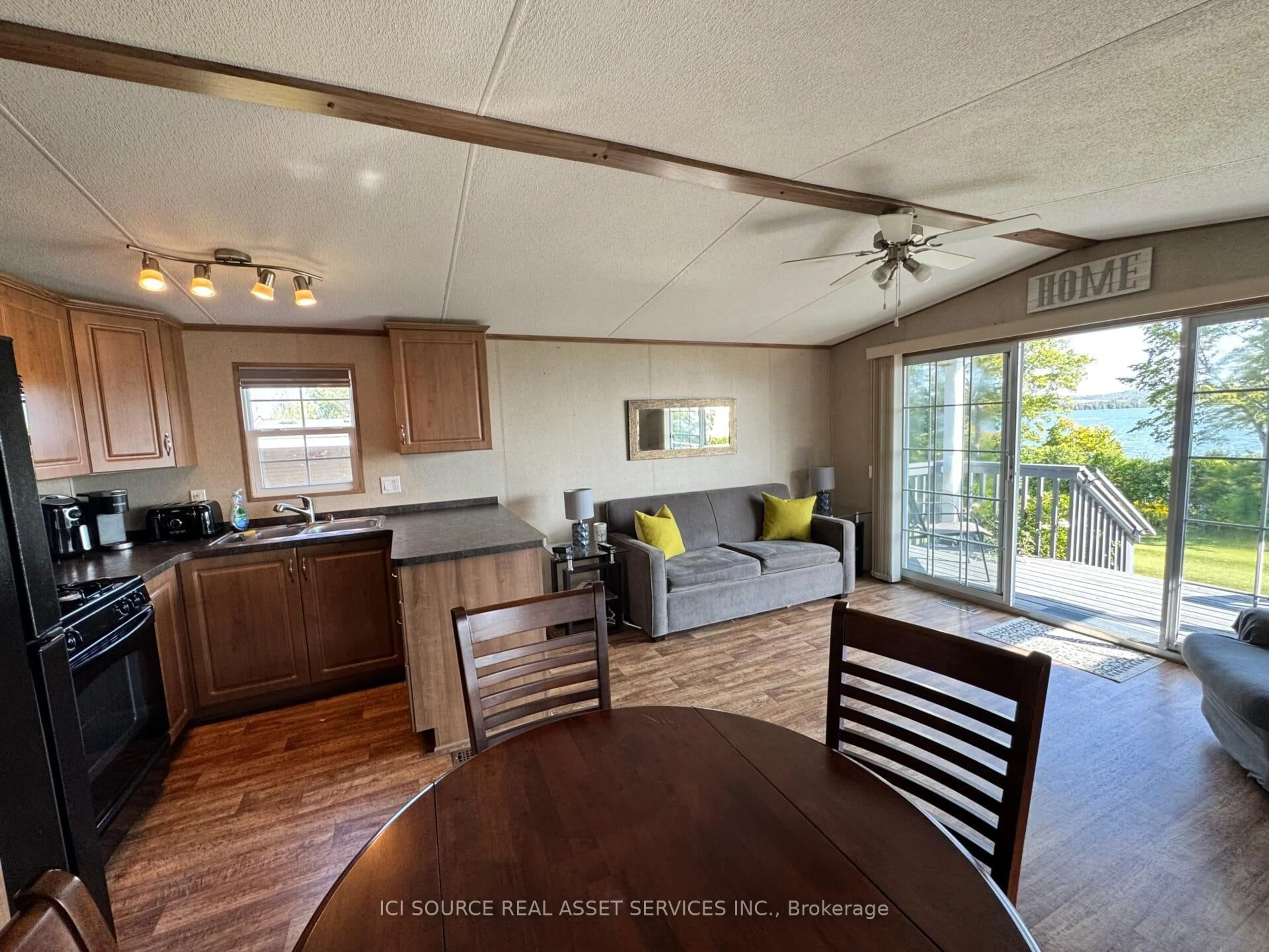 Open concept kitchen, wood/laminate floor for 1235 Villiers Line #ALX06, Otonabee-South Monaghan Ontario K0L 2G0