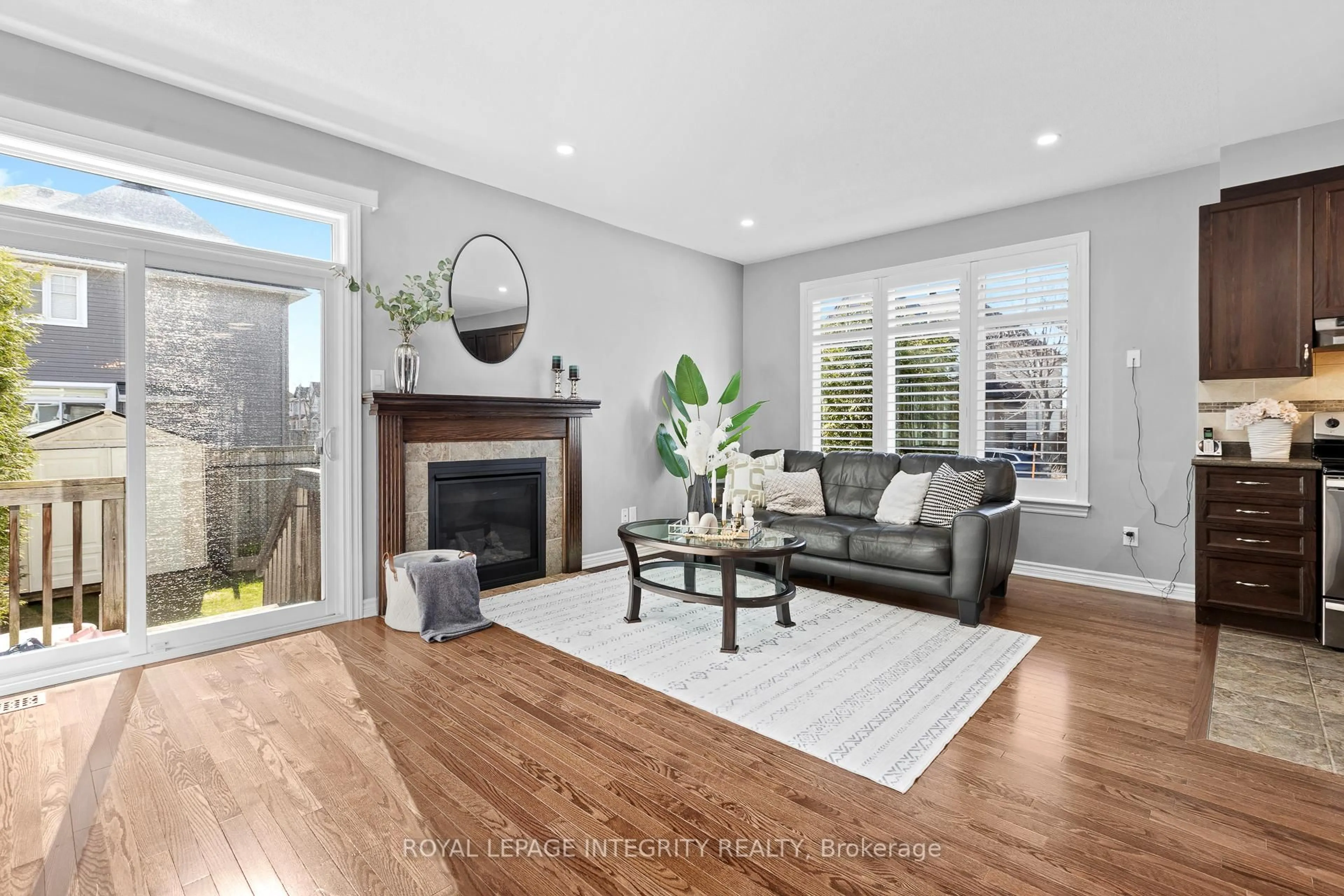 Living room with furniture, wood/laminate floor for 179 Flat Sedge Cres, Ottawa Ontario K1T 0G9