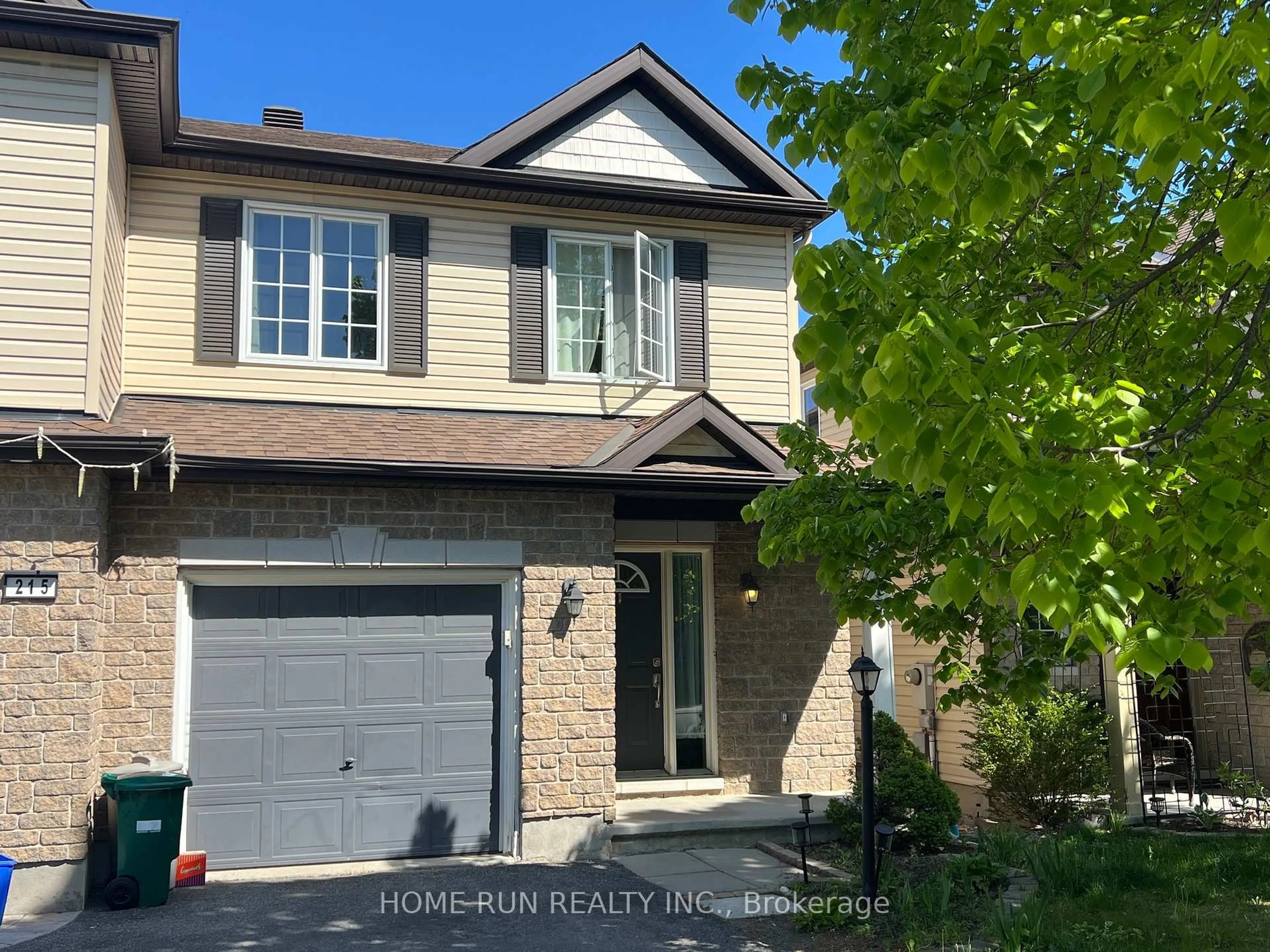 Home with vinyl exterior material, street for 217 Deerfox Dr, Ottawa Ontario K2J 4W8