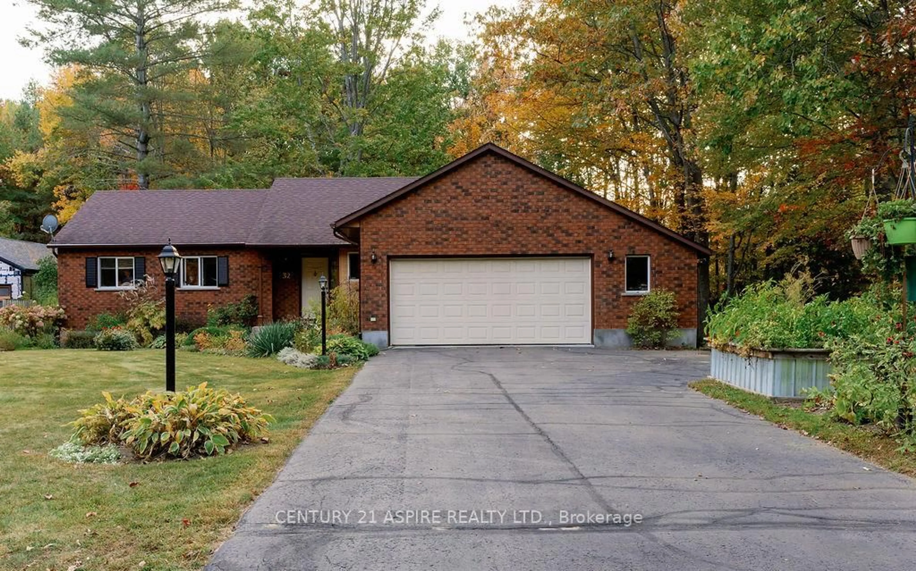 Home with brick exterior material, street for 32 Country Lane, Petawawa Ontario K8H 3J9