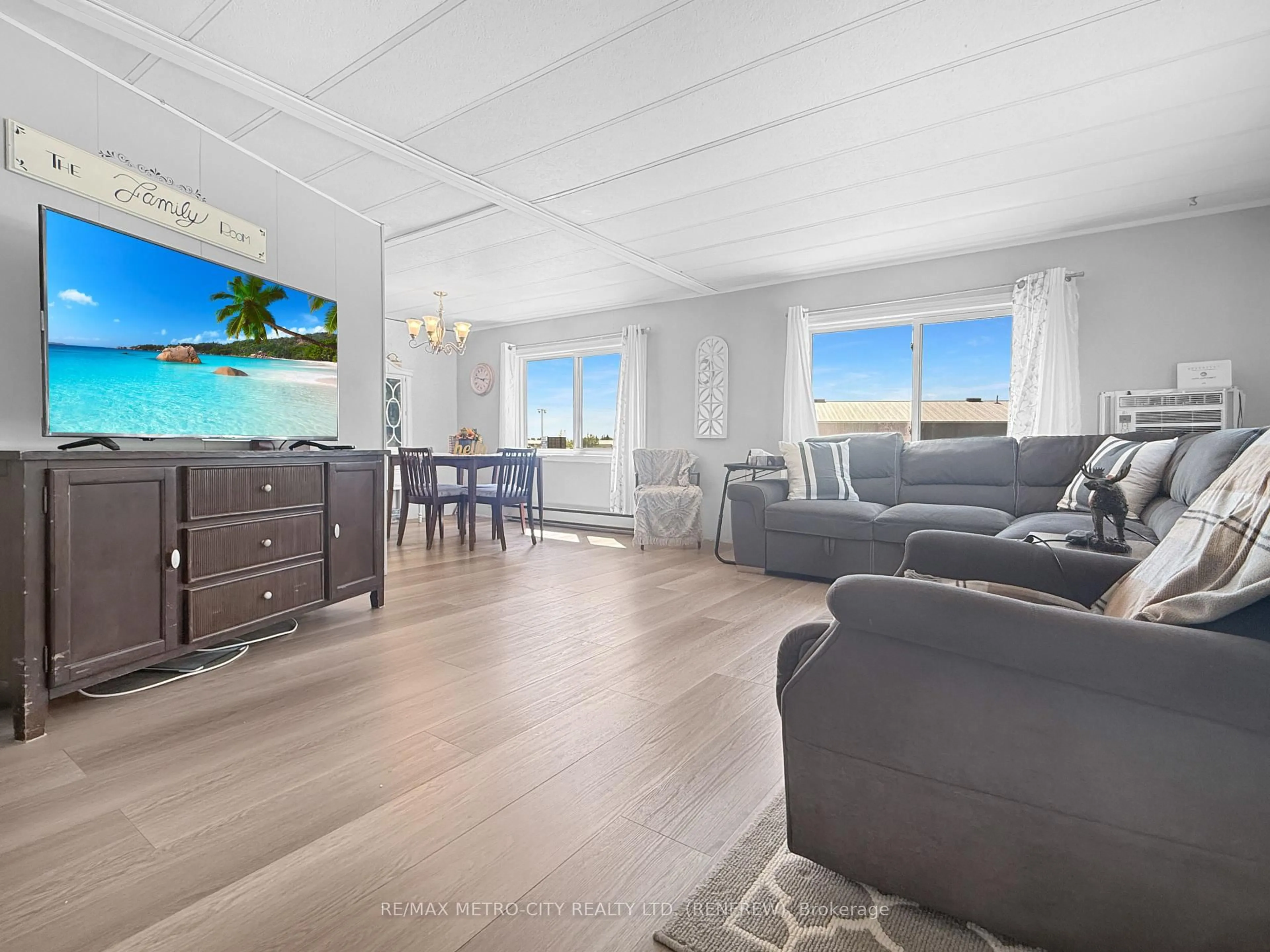 Living room with furniture, wood/laminate floor for 211 Elliott Cres, Renfrew Ontario K7V 3Z2
