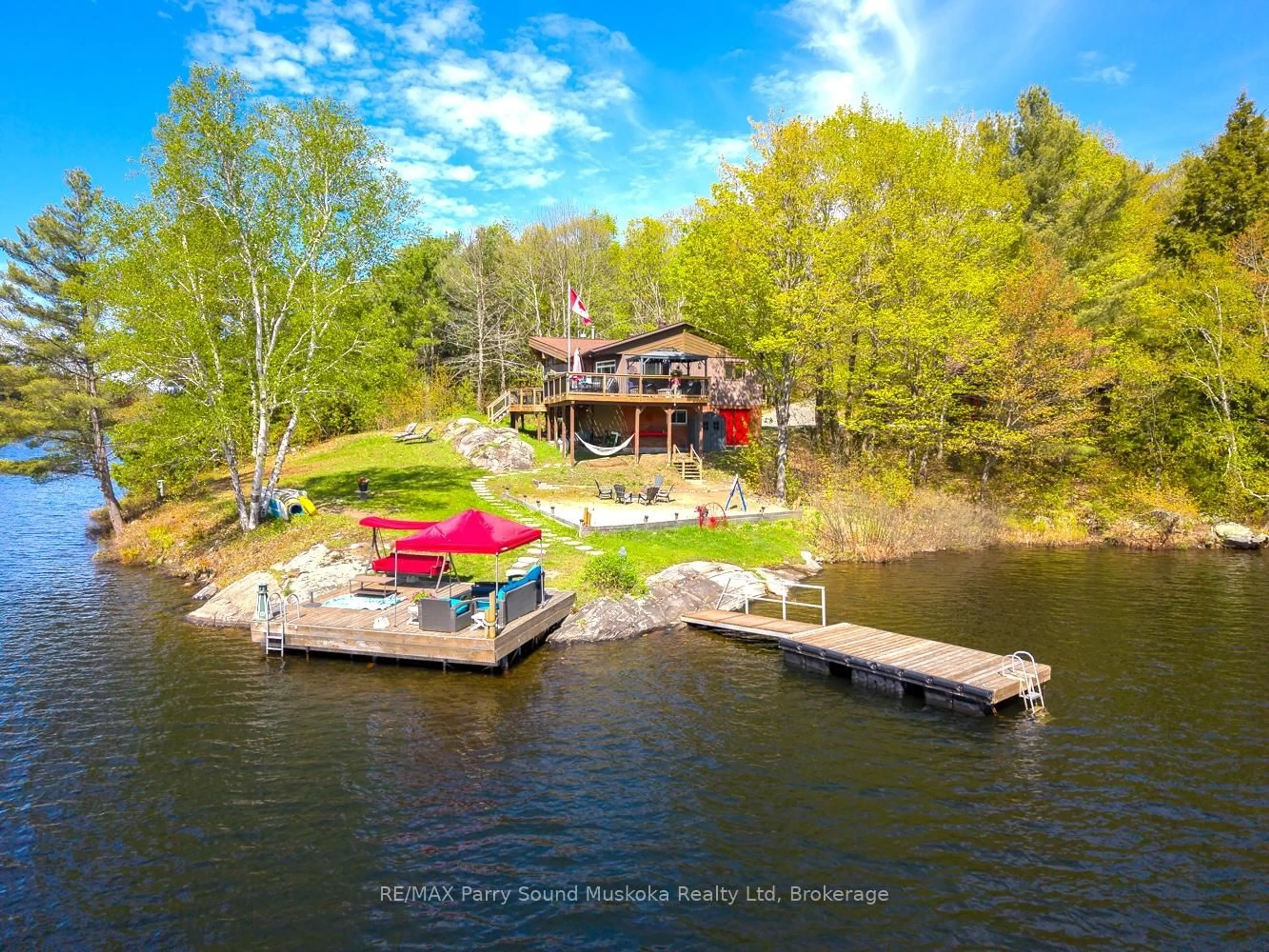 A pic from outside/outdoor area/front of a property/back of a property/a pic from drone, water/lake/river/ocean view for 207 Rankin Lk Rd, Seguin Ontario P2A 0B2