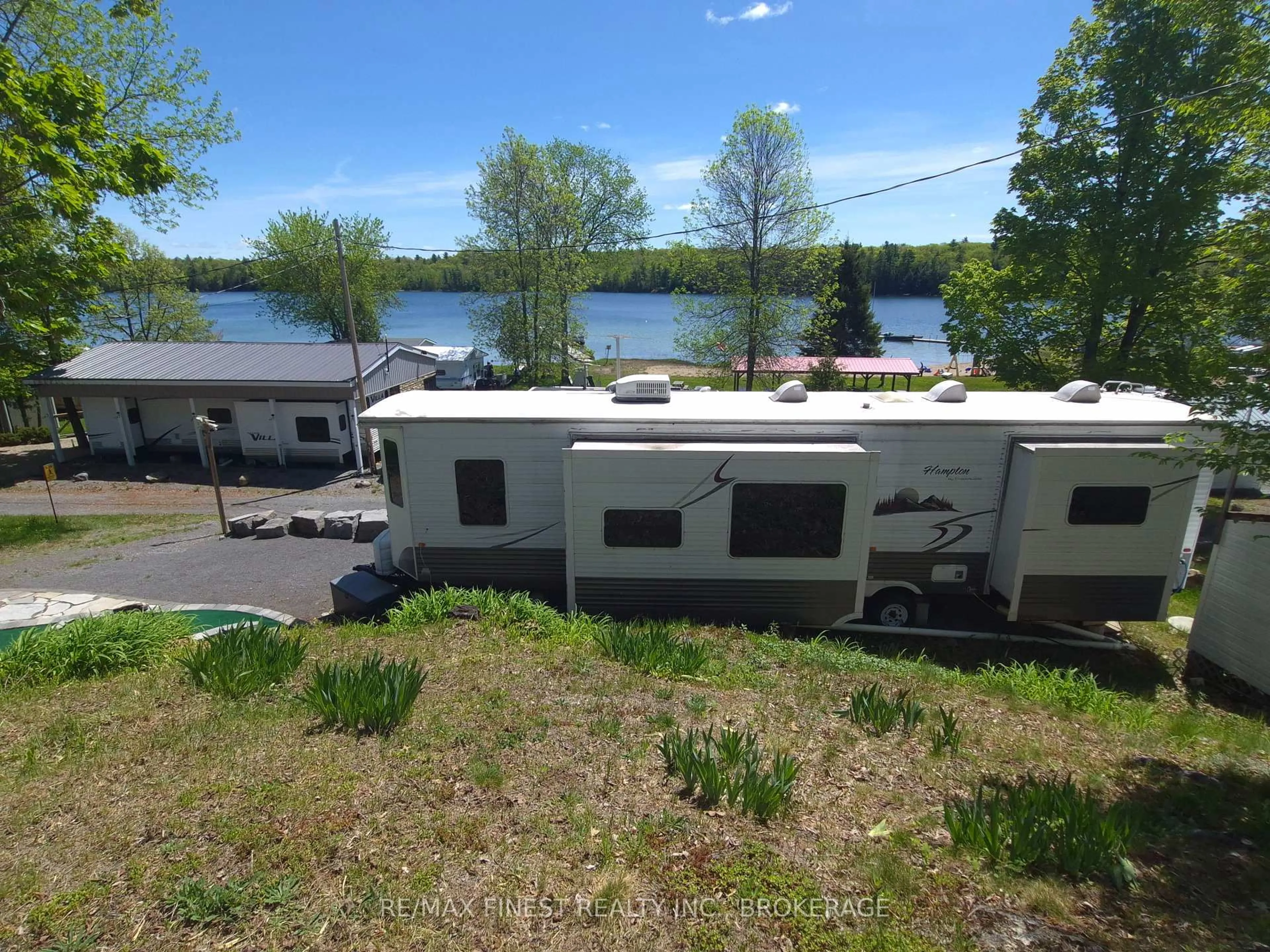 A pic from outside/outdoor area/front of a property/back of a property/a pic from drone, water/lake/river/ocean view for 9 Glenford Lane #36, Godfrey Ontario K0H 1T0