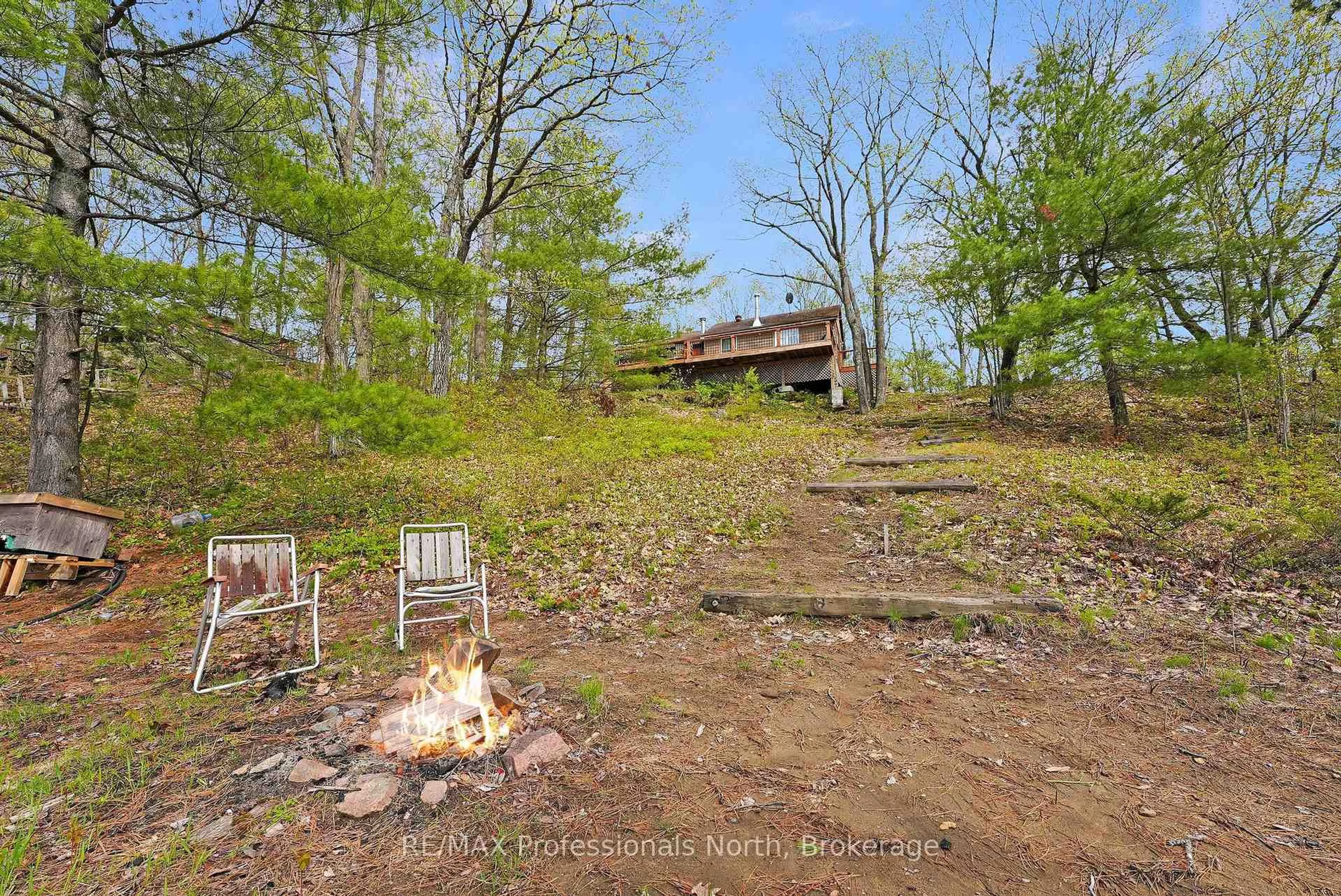 A pic from outside/outdoor area/front of a property/back of a property/a pic from drone, forest/trees view for 1012 Iroquois Lane, Minden Hills Ontario K0M 2K0