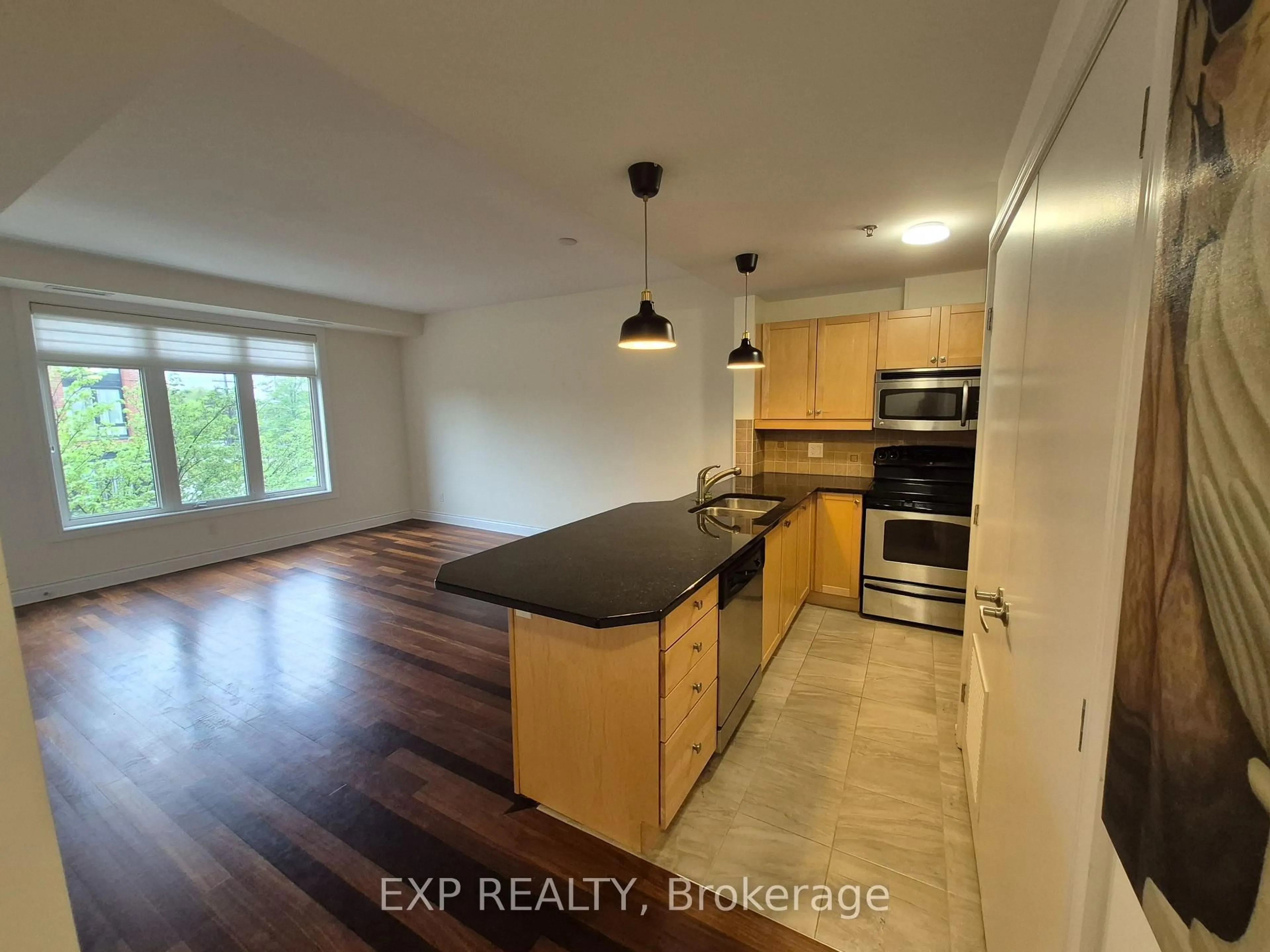 Open concept kitchen, wood/laminate floor for 323 Winona Ave #10, Ottawa Ontario K1Z 5H3