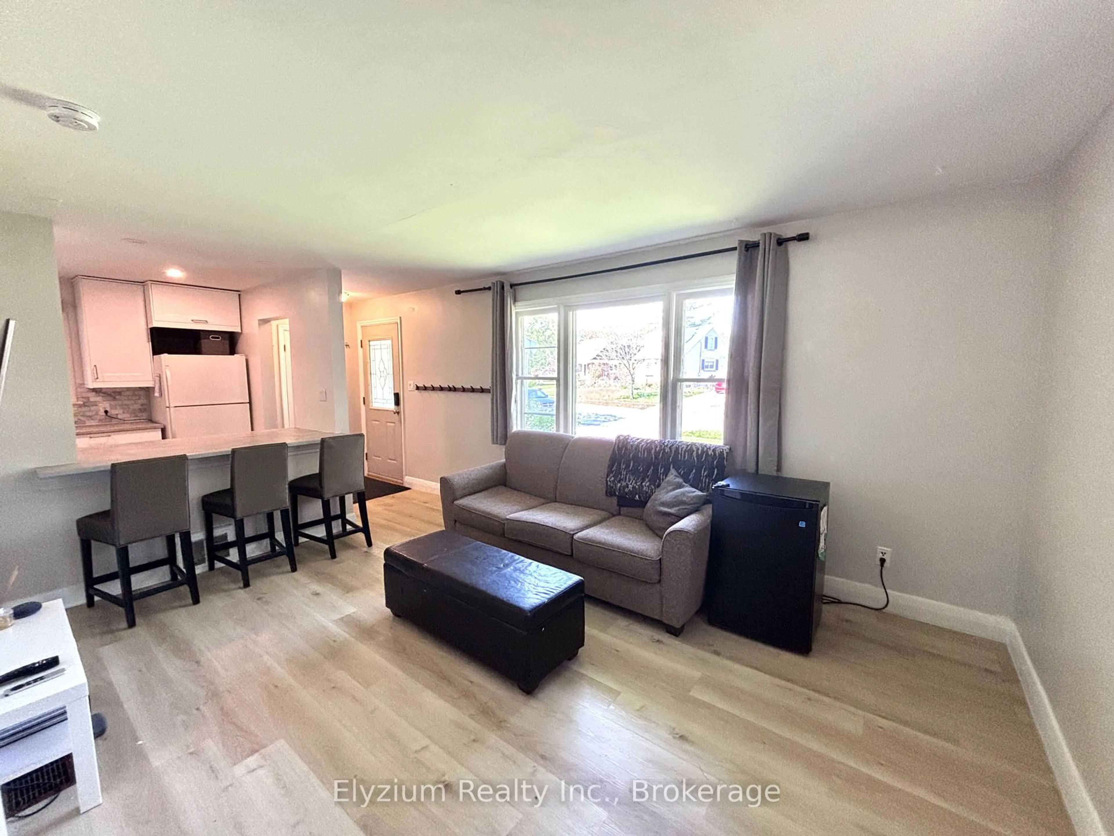 Living room with furniture, wood/laminate floor for 31 Vancouver Dr, Guelph Ontario N1E 2E7