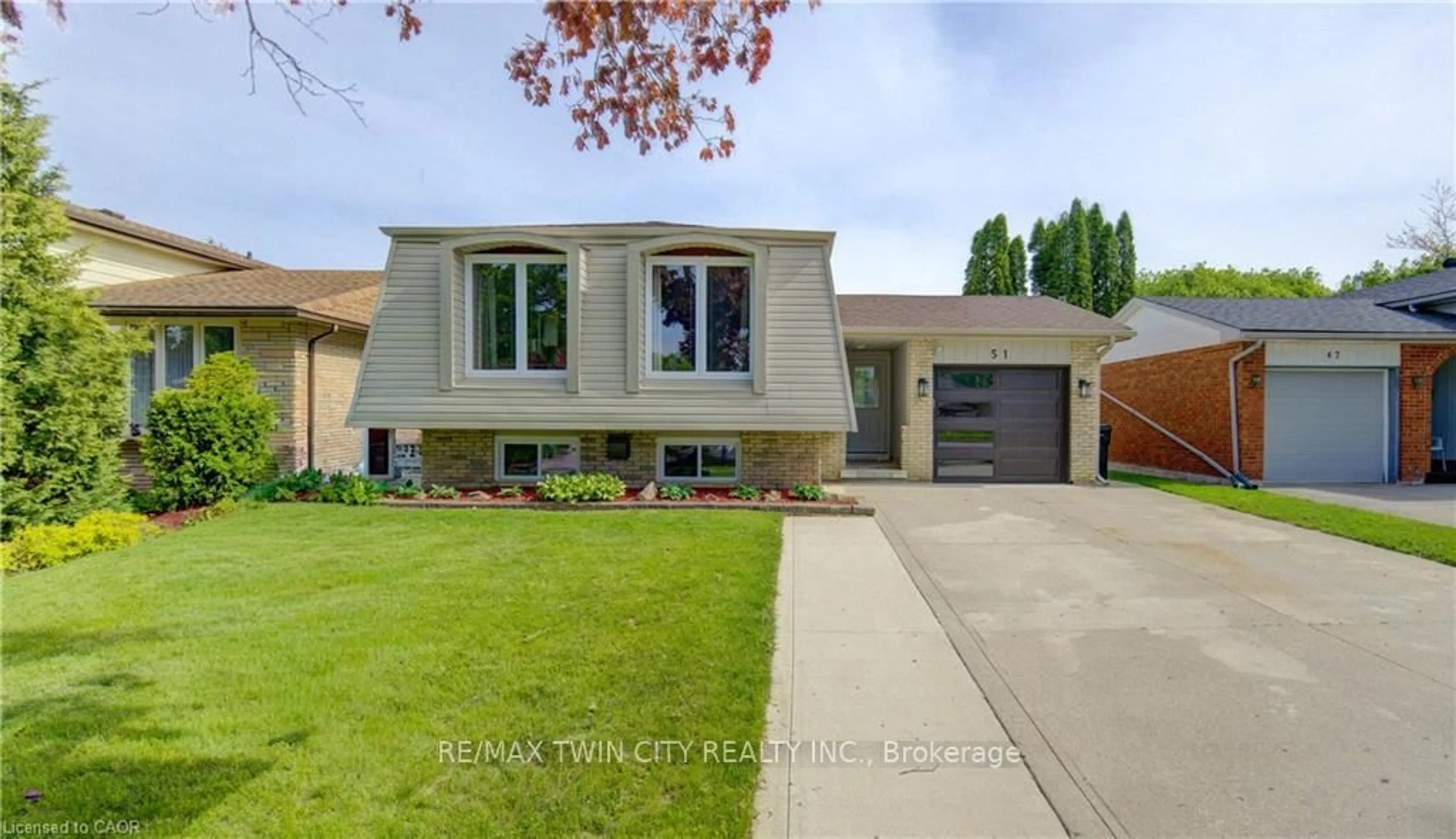Home with brick exterior material, street for 51 COACH HILL Dr, Kitchener Ontario N2E 1N7