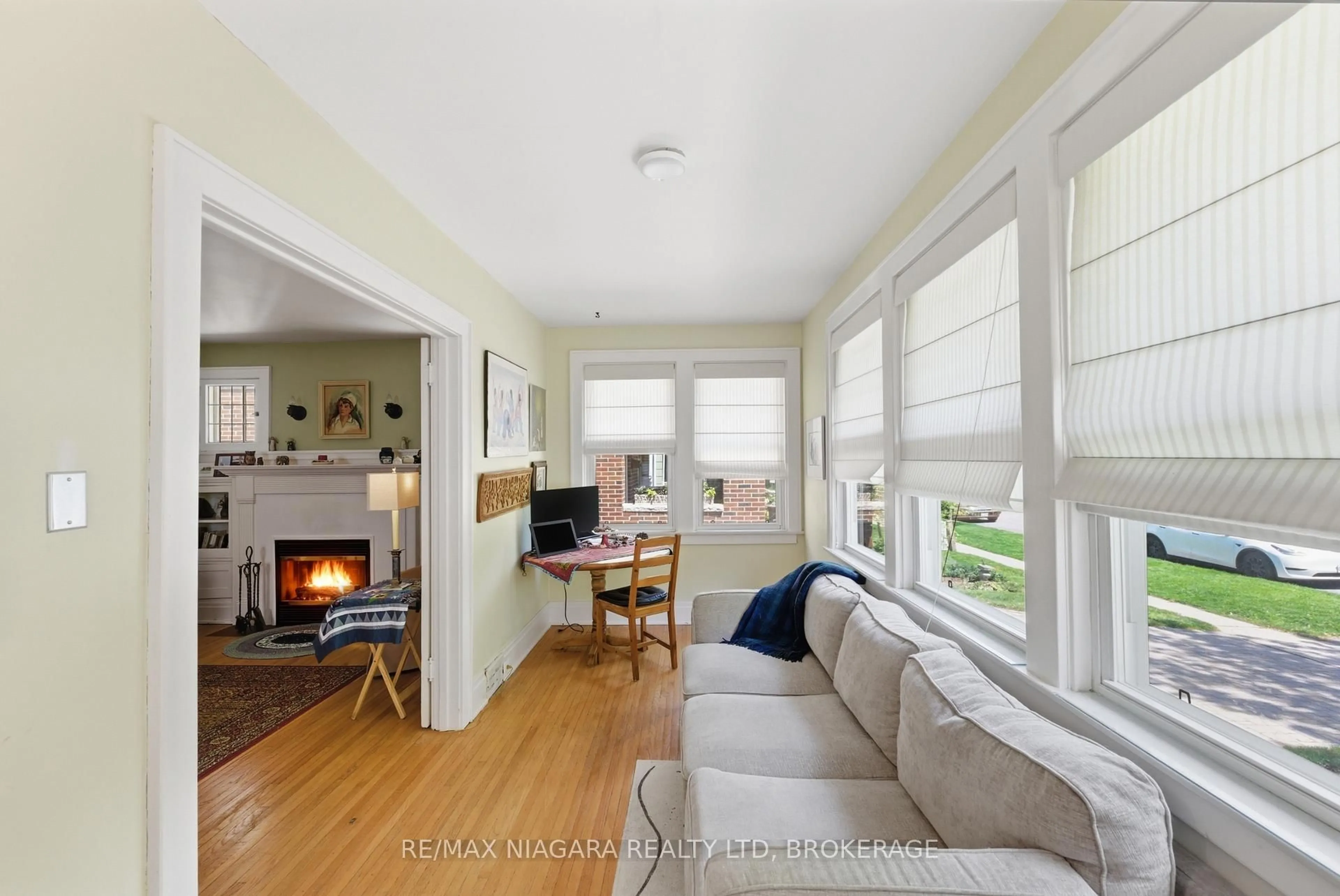 Living room with furniture, wood/laminate floor for 15 1/2 Wolesley Ave, St. Catharines Ontario L2R 4T4