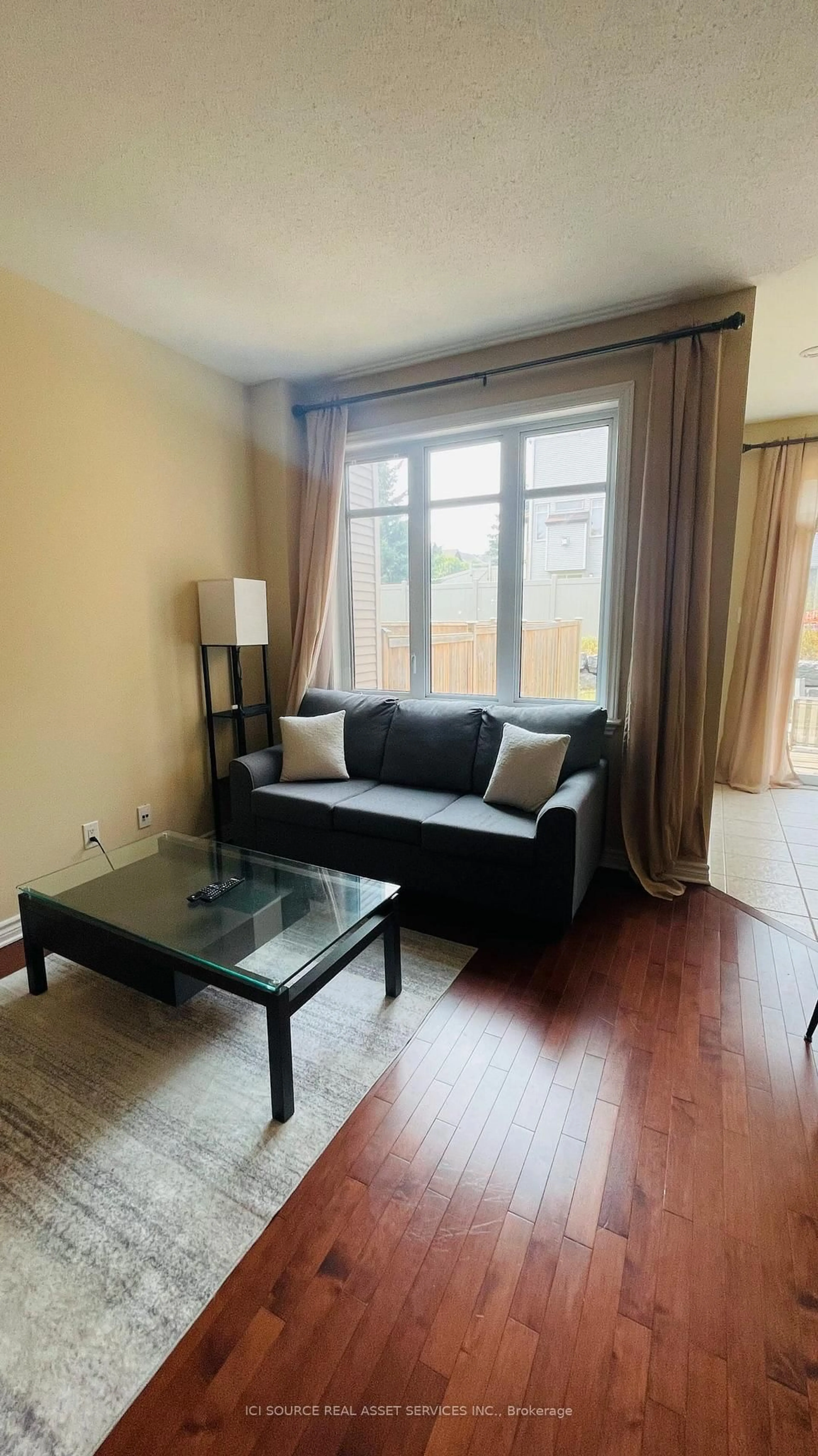 Living room with furniture, wood/laminate floor for 27 Torbec Ave, Ottawa Ontario K2T 0B6