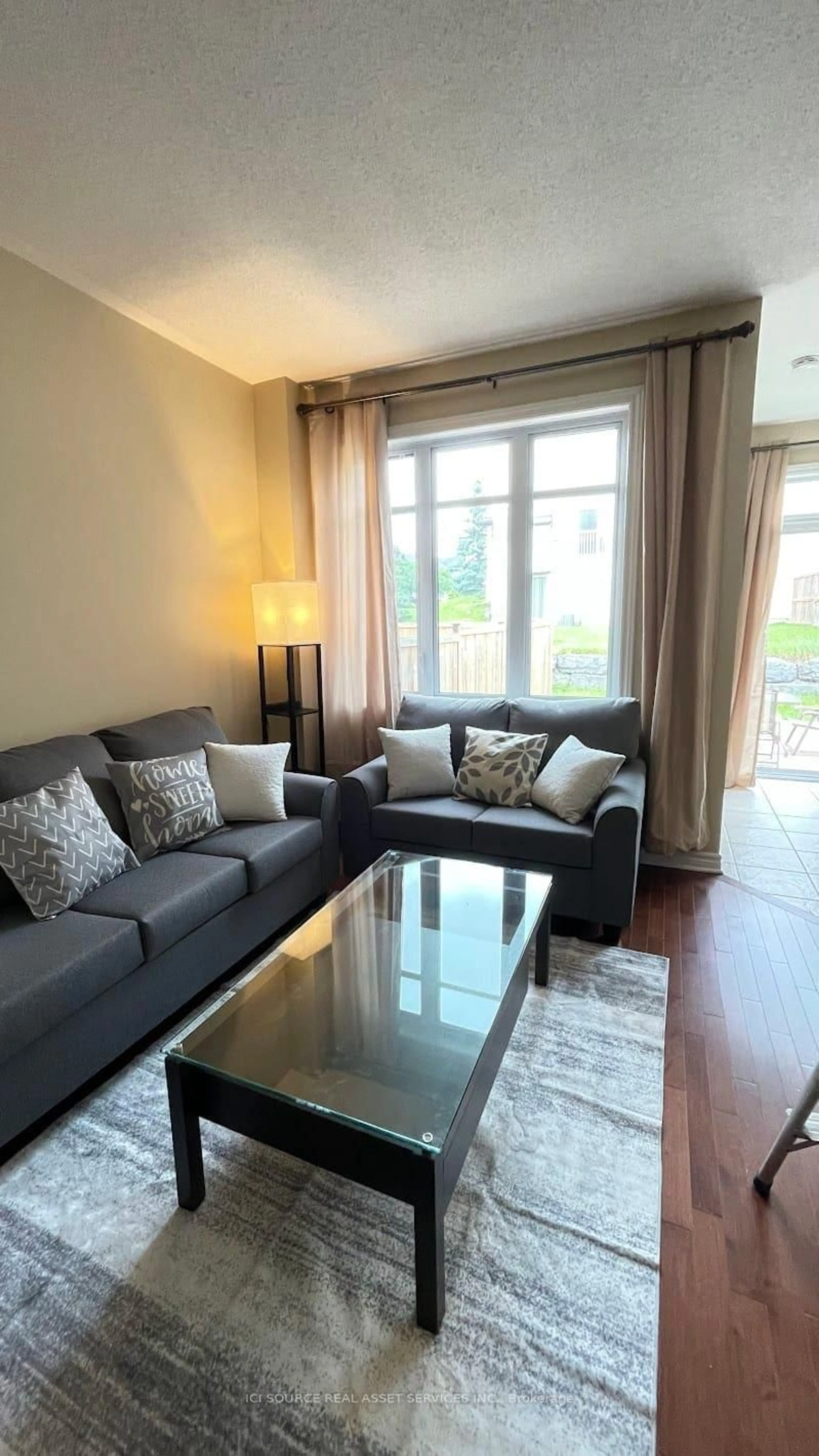 Living room with furniture, wood/laminate floor for 27 Torbec Ave, Ottawa Ontario K2T 0B6
