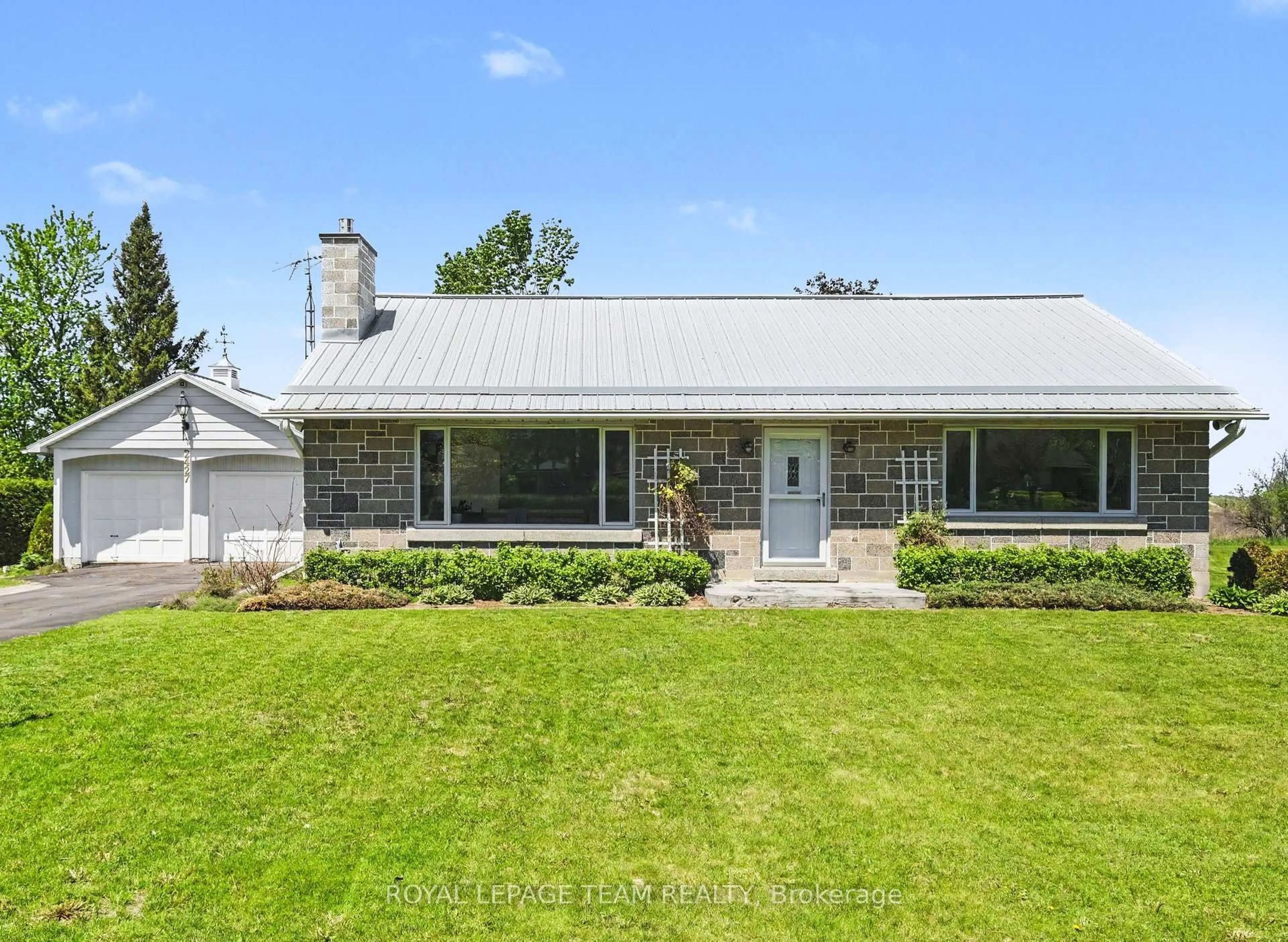 A pic from outside/outdoor area/front of a property/back of a property/a pic from drone, street for 2427 County Rd 18, North Grenville Ontario K0G 1J0