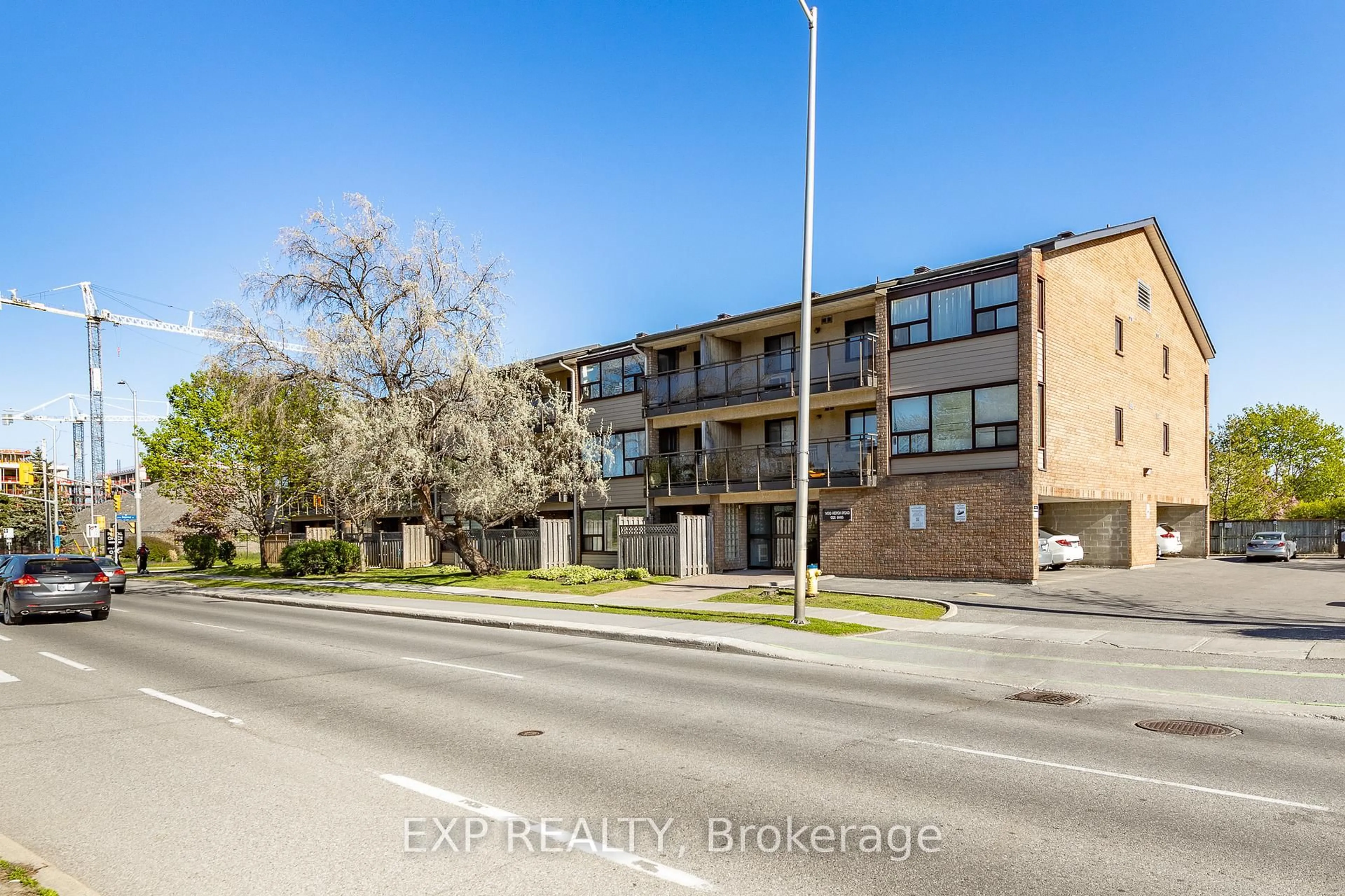 A pic from outside/outdoor area/front of a property/back of a property/a pic from drone, street for 1490 Heron Rd #305, Ottawa Ontario K1V 6A5