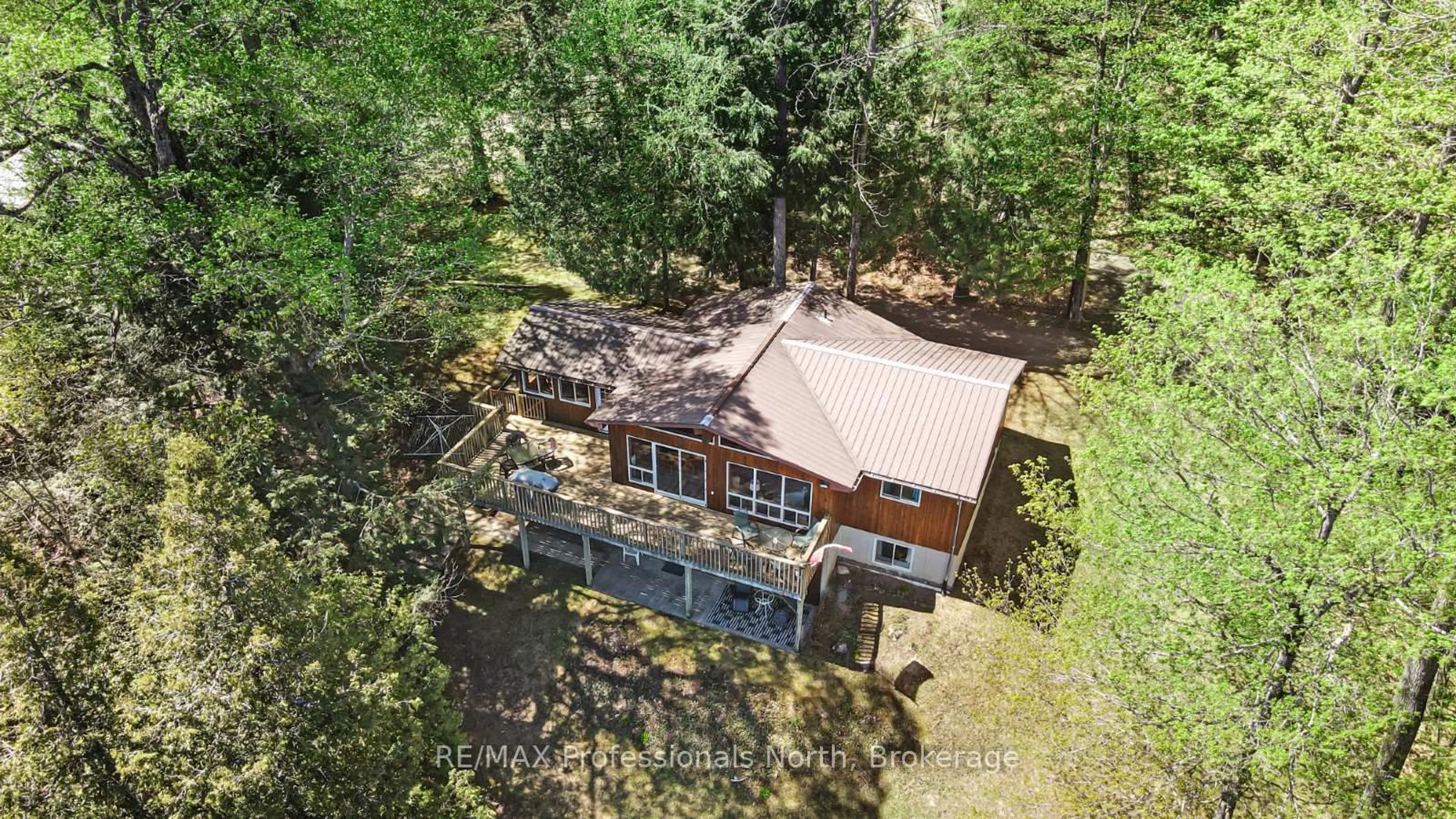 A pic from outside/outdoor area/front of a property/back of a property/a pic from drone, forest/trees view for 1149 Harrison Bay Lane, Minden Hills Ontario K0M 2K0